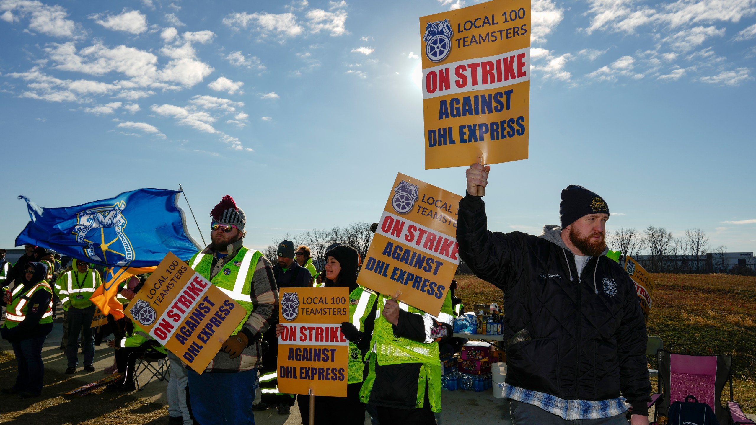 Teamsters protest at Cincinnati/Northern Kentucky International Airport near the DHL Express Hub Friday, Dec. 8, 2023, in Erlanger ,Ky. More than 1,000 union members at DHL walked off the job at Cincinnati/Northern Kentucky International Airport, a critical logistics hub for the package delivery company, during the busiest time of the year. The Teamsters say they are protesting unfair labor practices at the DHL Express hub. (AP Photo/Carolyn Kaster)