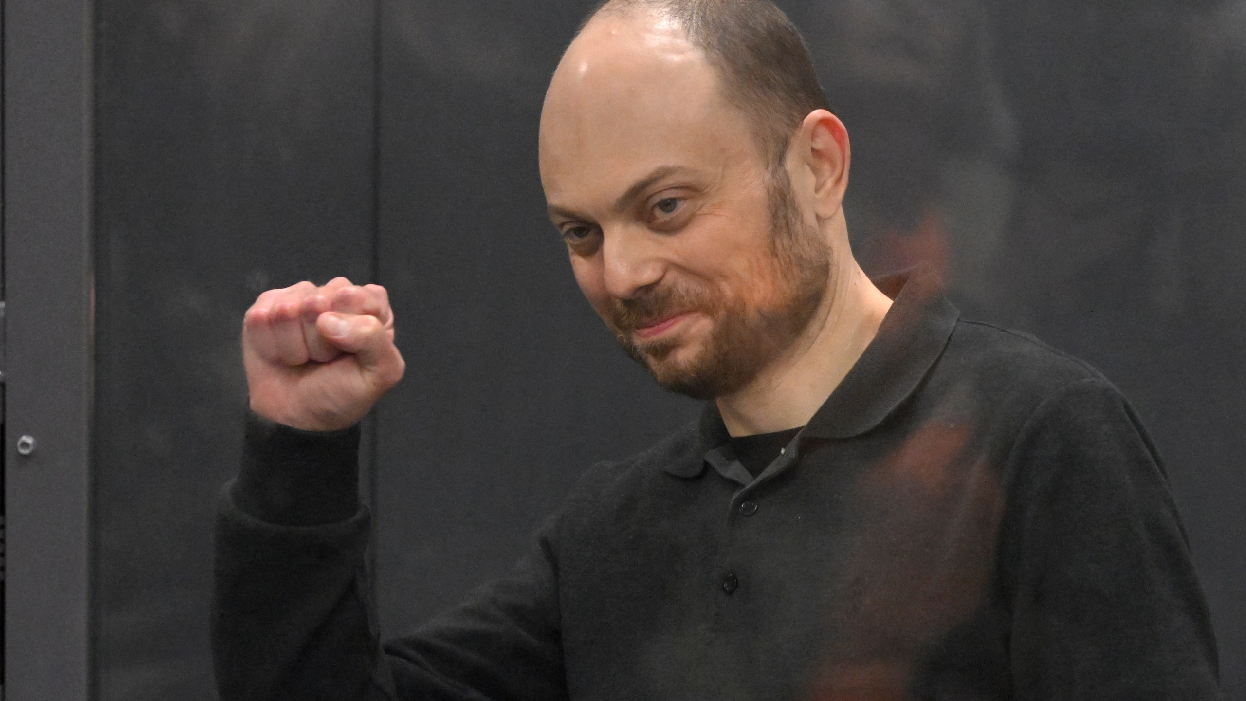 FILE - Russian opposition activist Vladimir Kara-Murza gestures standing in a glass cage in a courtroom during announcement of the verdict on appeal at the Moscow City Court in Moscow, Russia, on July 31, 2023. Most Russian opposition figures are either in prison at home or are in exile abroad. But they vow that they will still put up a fight against President Vladimir Putin as he seeks yet another term in office in an election scheduled for March.(AP Photo, File)