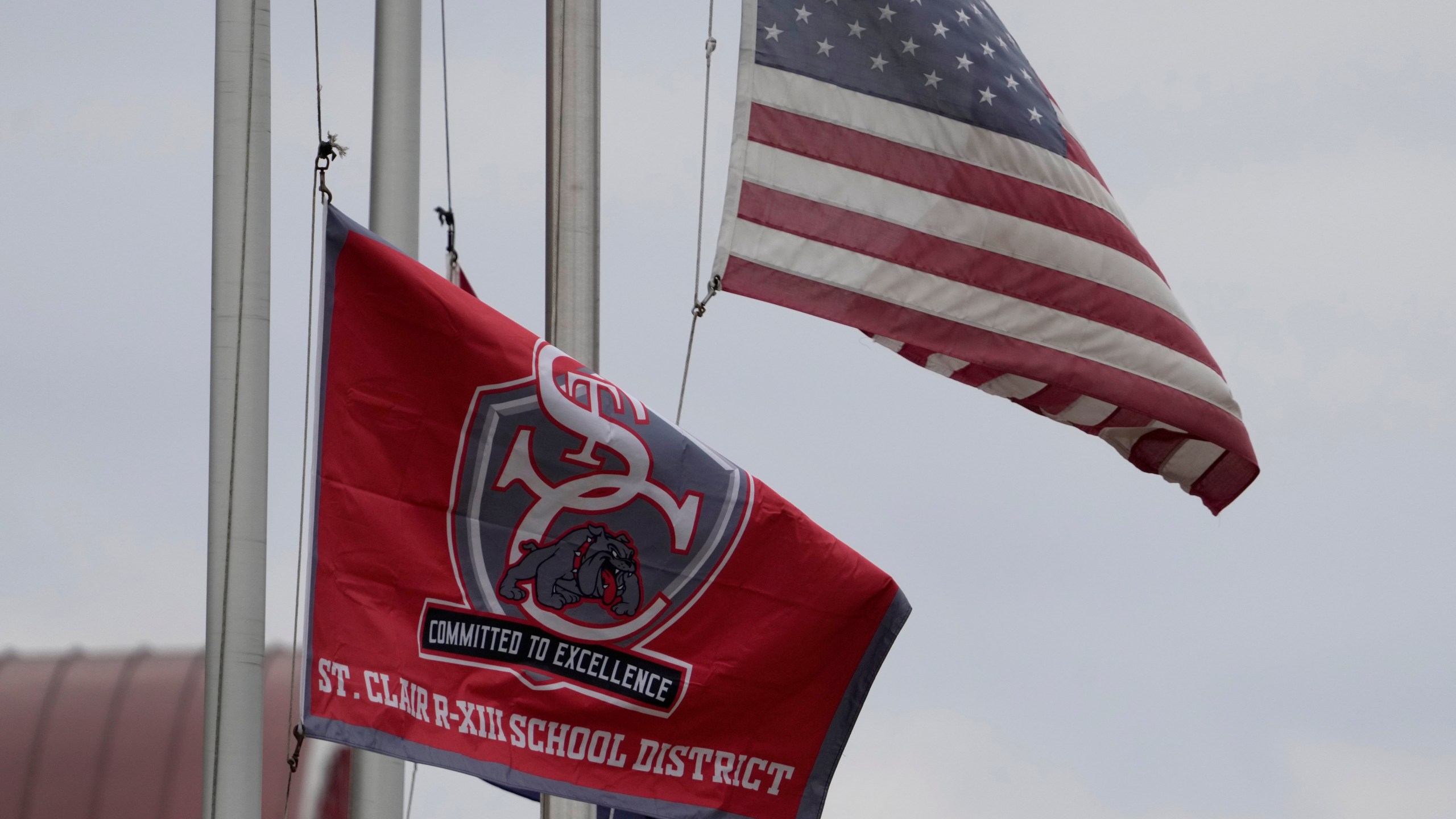 A St. Clair School District flag flies outside an elementary school, Friday, Dec. 8, 2023, in St. Clair, Mo. Two teachers at the district's rural Missouri high school have resigned after it was discovered they were posting racy content on the subscription platform OnlyFans. (AP Photo/Jeff Roberson)