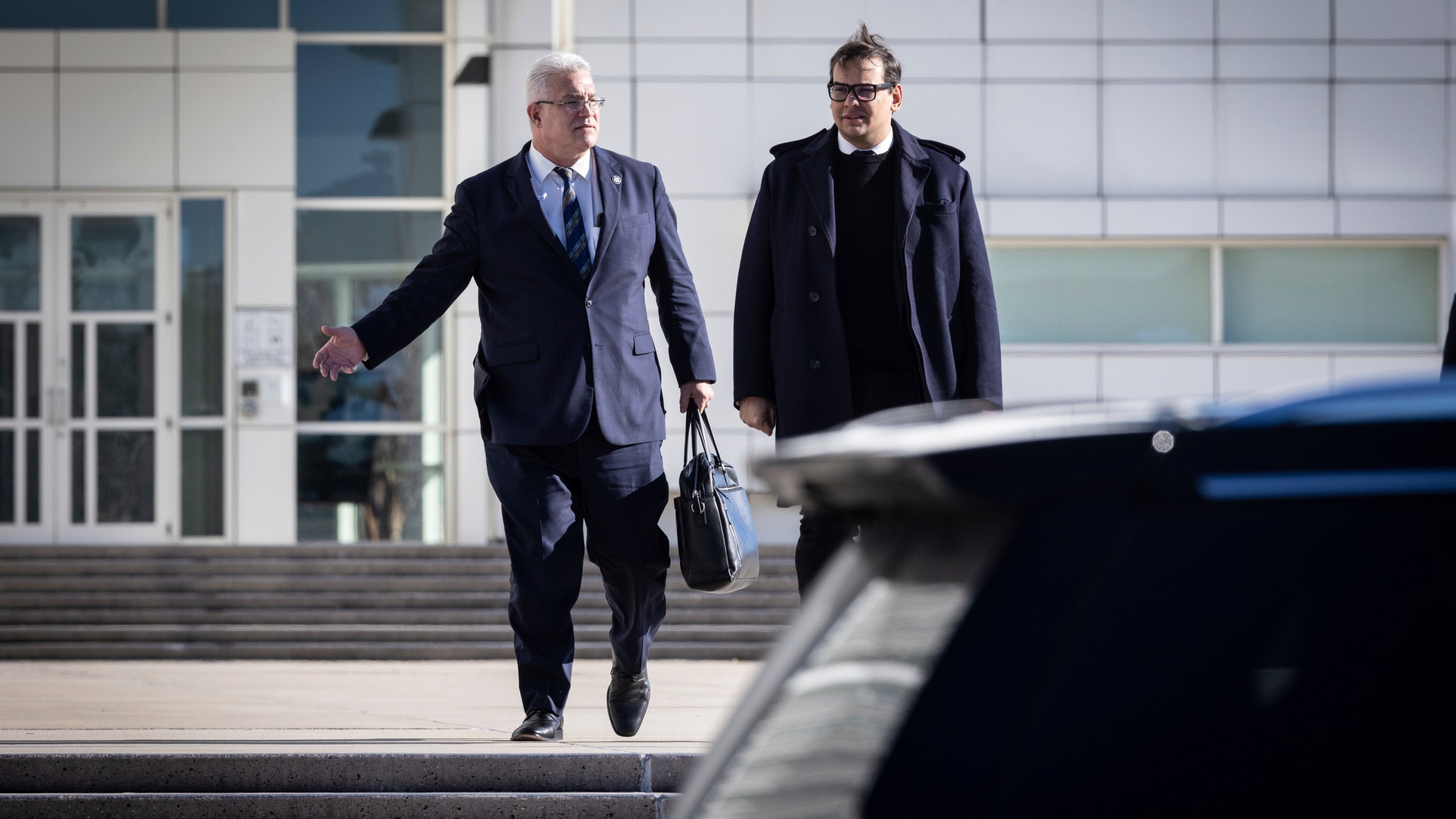 Former U.S. Rep George Santos leaves the federal courthouse with his lawyer in Central Islip, N.Y. on, Tuesday, Dec. 12, 2023, in New York. (AP Photo/Stefan Jeremiah)