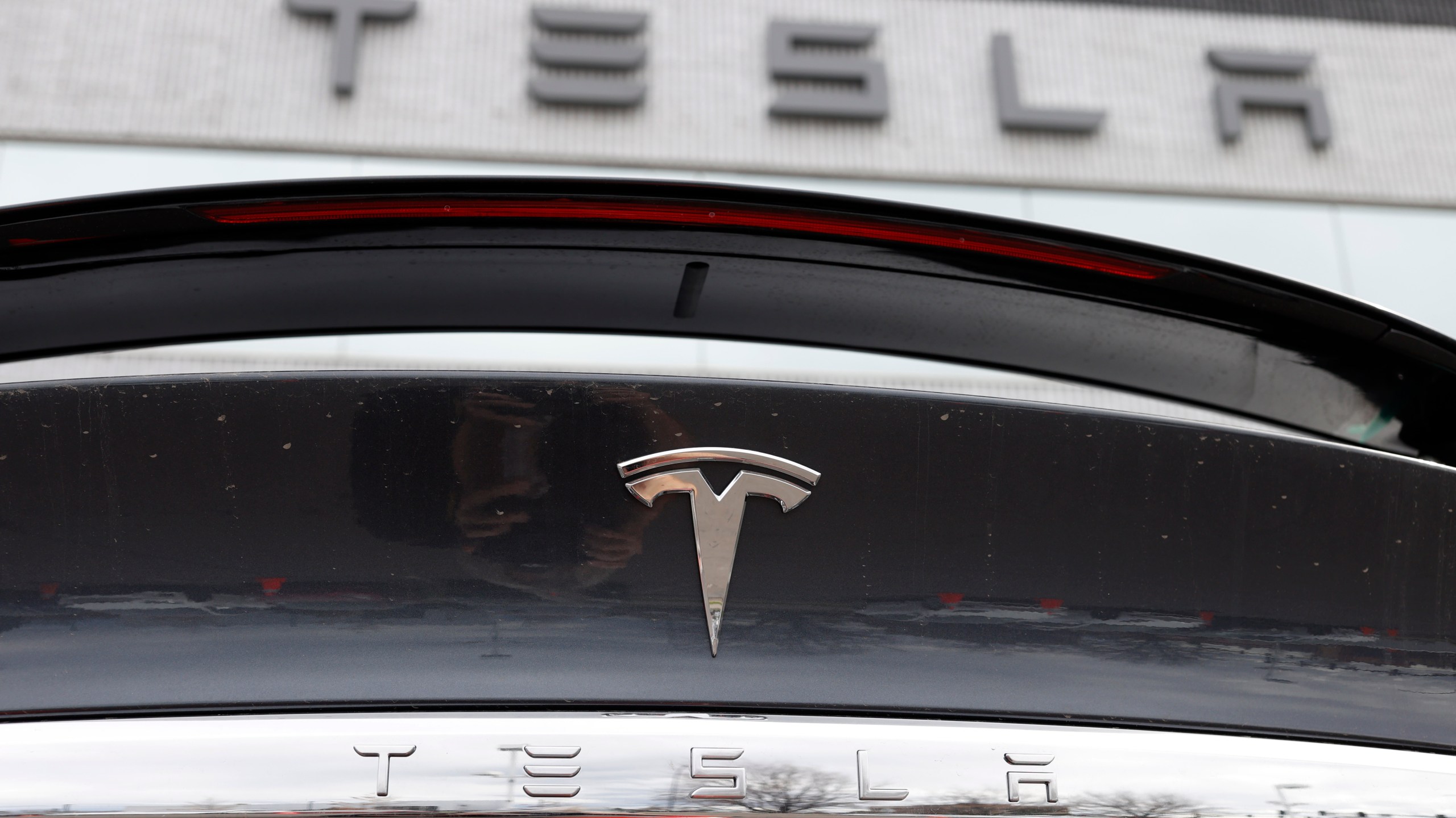 FILE - The Tesla company logo shines off the rear deck of an unsold 2020 Model X at a Tesla dealership, April 26, 2020, in Littleton, Colo. On Tuesday, Dec. 12, 2023, Virginia authorities determined that a Tesla was operating on its Autopilot system and was speeding in the moments leading to a crash with a crossing tractor-trailer last July that killed the Tesla driver. (AP Photo/David Zalubowski, File)