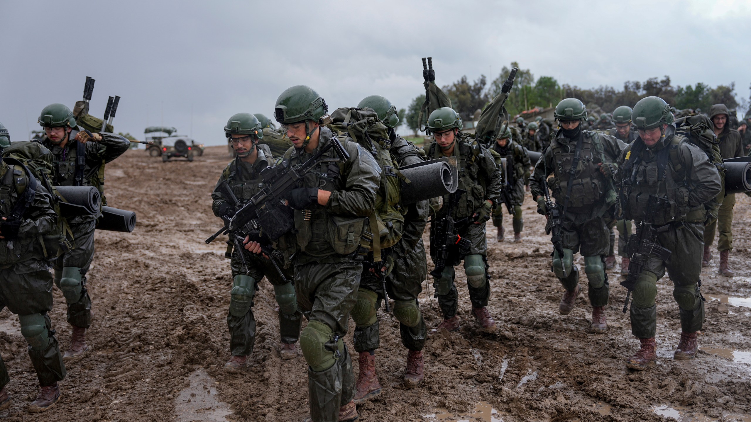 Israeli soldiers prepare to enter the Gaza Strip, at a staging area near the Israeli-Gaza border, in southern Israel, Wednesday, Dec. 13, 2023. The army is battling Palestinian militants across Gaza in the war ignited by Hamas' Oct. 7 attack into Israel. (AP Photo/Ohad Zwigenberg)