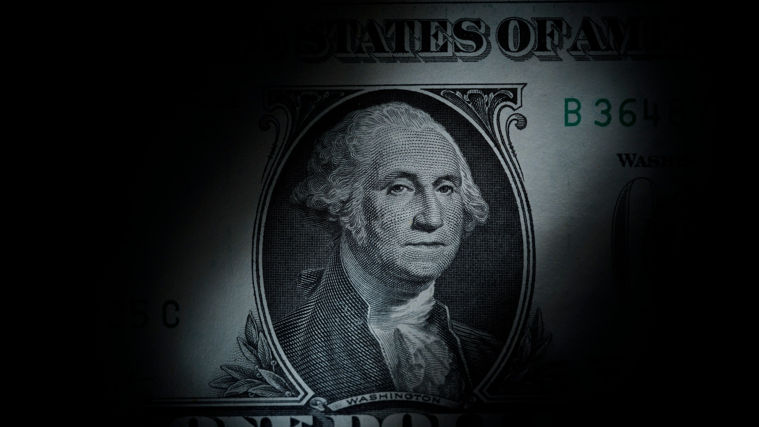 FILE - The likeness of George Washington is seen on a U.S. one dollar bill, March 13, 2023, in Marple Township, Pa. The Congressional Budget Office said Friday, Dec. 15, that it expects inflation to nearly hit the Federal Reserve's 2% target rate in 2024, as overall growth is expected to slow and unemployment is expected to rise into 2025, according to updated economic projections for the next two years. (AP Photo/Matt Slocum, File)