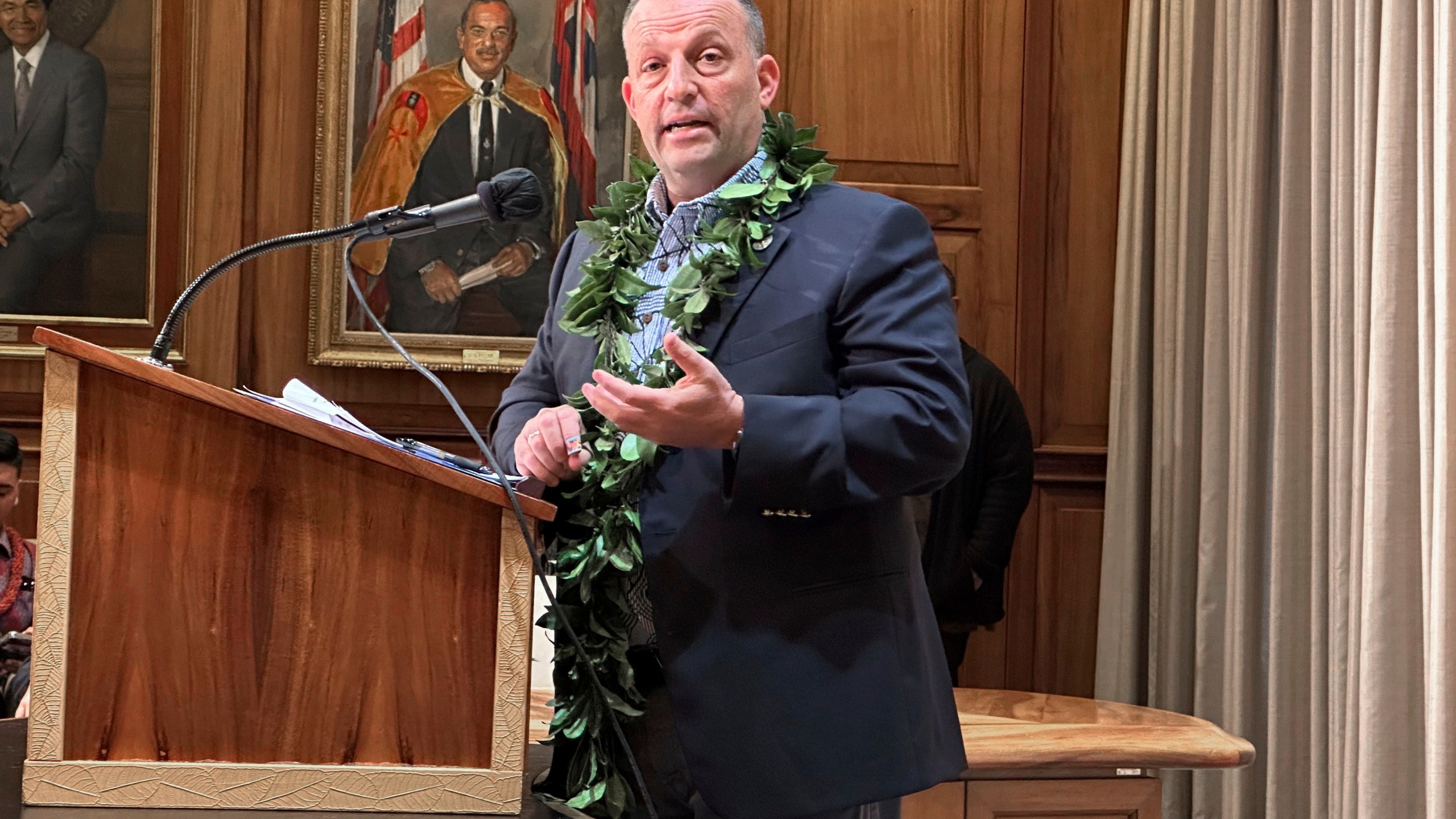 Hawaii Gov. Josh Green speaks at a news conference in Honolulu on Friday, Dec. 15, 2023. Green on Friday said he wants 3,000 condos and homes normally rented to Maui tourists on a short-term basis converted to long-term housing for displaced wildfire survivors who are now living in hotels and will use his emergency powers to achieve this if necessary.(AP Photo/Audrey McAvoy)