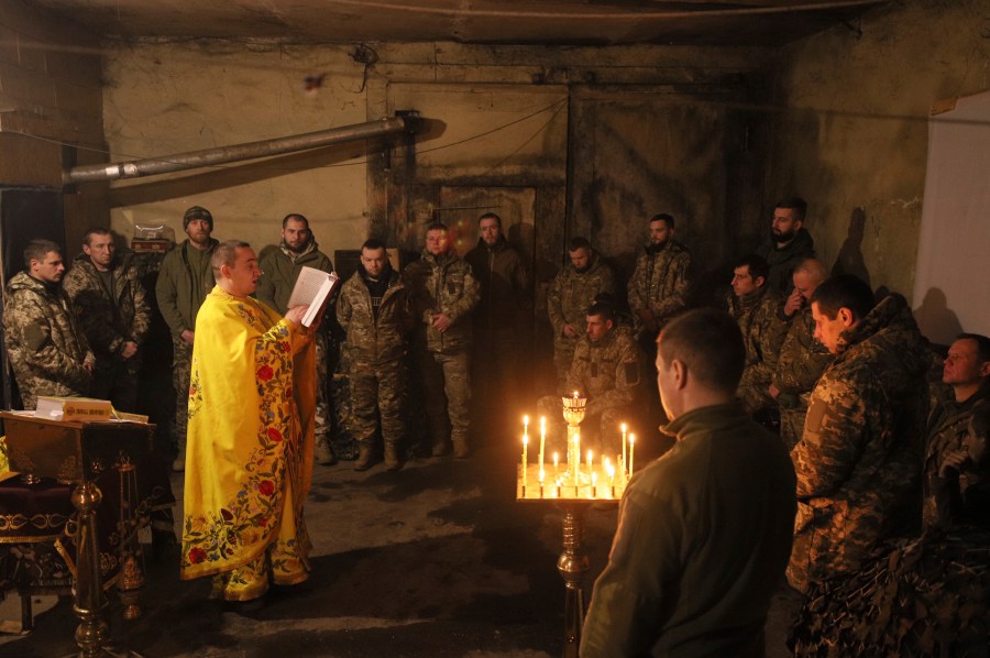 Chaplain Ivan of the Orthodox Church of Ukraine reads a prayer for Ukrainian servicemen of the 72nd mechanized brigade during the sacred liturgy before the upcoming Christmas at the frontline near Vuhledar, Ukraine, Friday, Dec. 15, 2023. (AP Photo/Valentyn Kuzan)