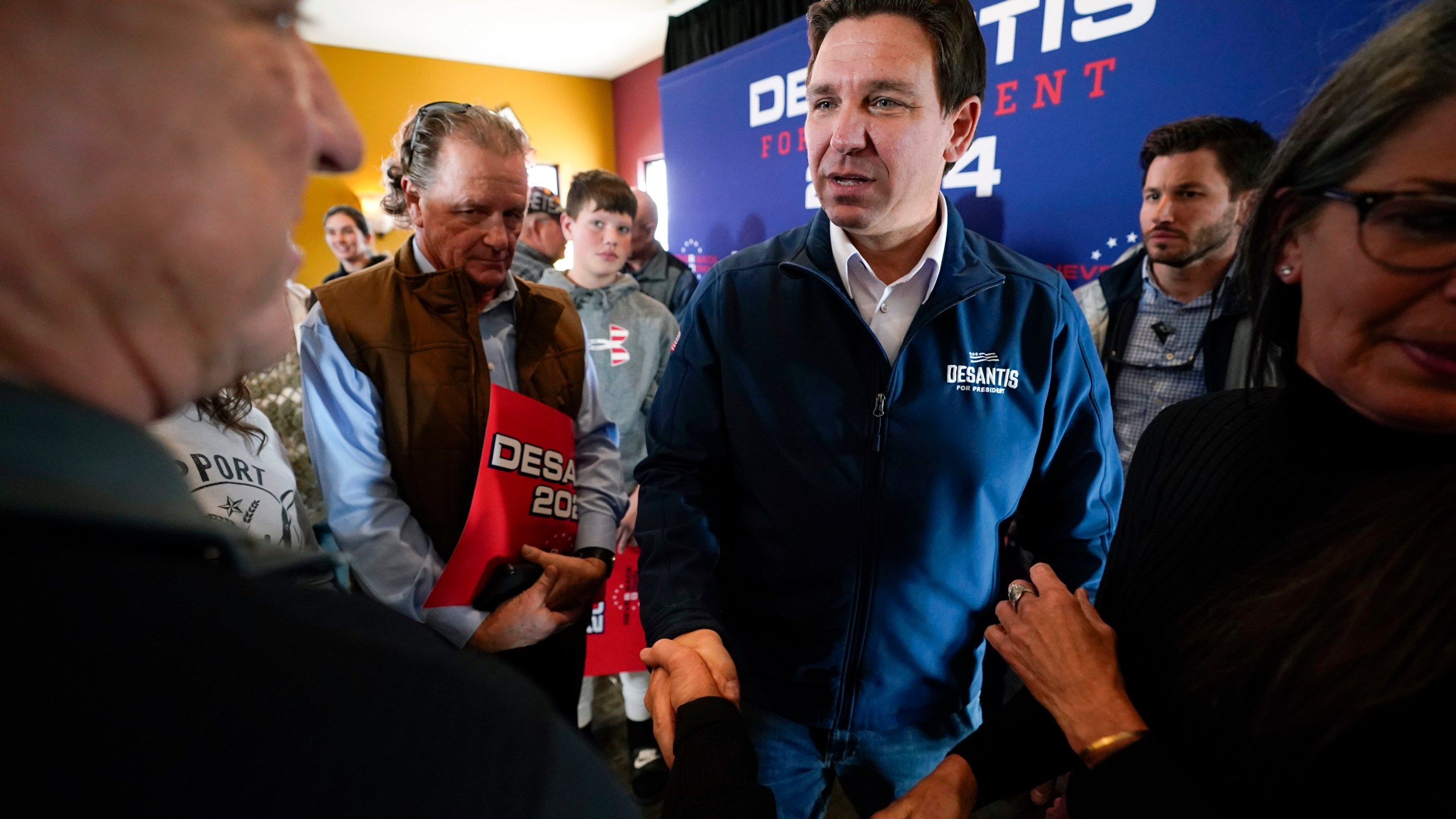 FILE - Republican presidential candidate Florida Gov. Ron DeSantis talks with audience members during a meet and greet, Friday, Nov. 3, 2023, in Denison, Iowa. Former President Donald Trump was the first choice of 51% of likely Iowa caucus participants in a Des Moines Register-NBC News-Mediacom Iowa Poll published Monday, Dec. 11. Florida Gov. Ron DeSantis, who has vowed that he will win Iowa, had the support of 19%. (AP Photo/Charlie Neibergall, File)