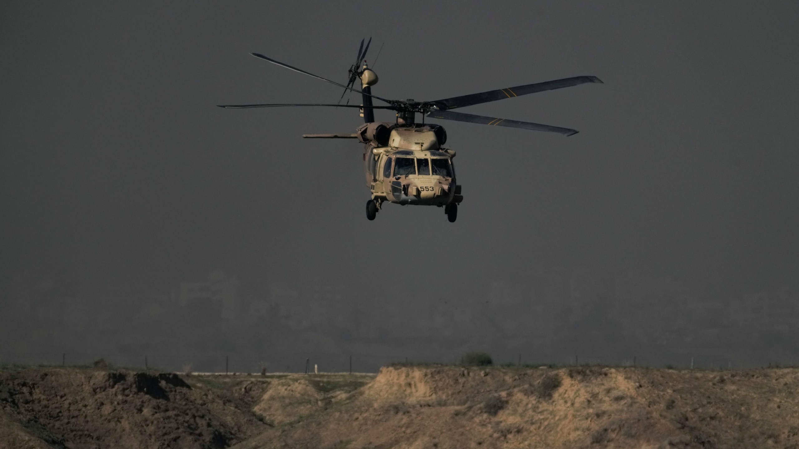 Israeli military helicopter flies out of the Gaza Strip, Monday, Dec. 18, 2023. (AP Photo/Leo Correa)