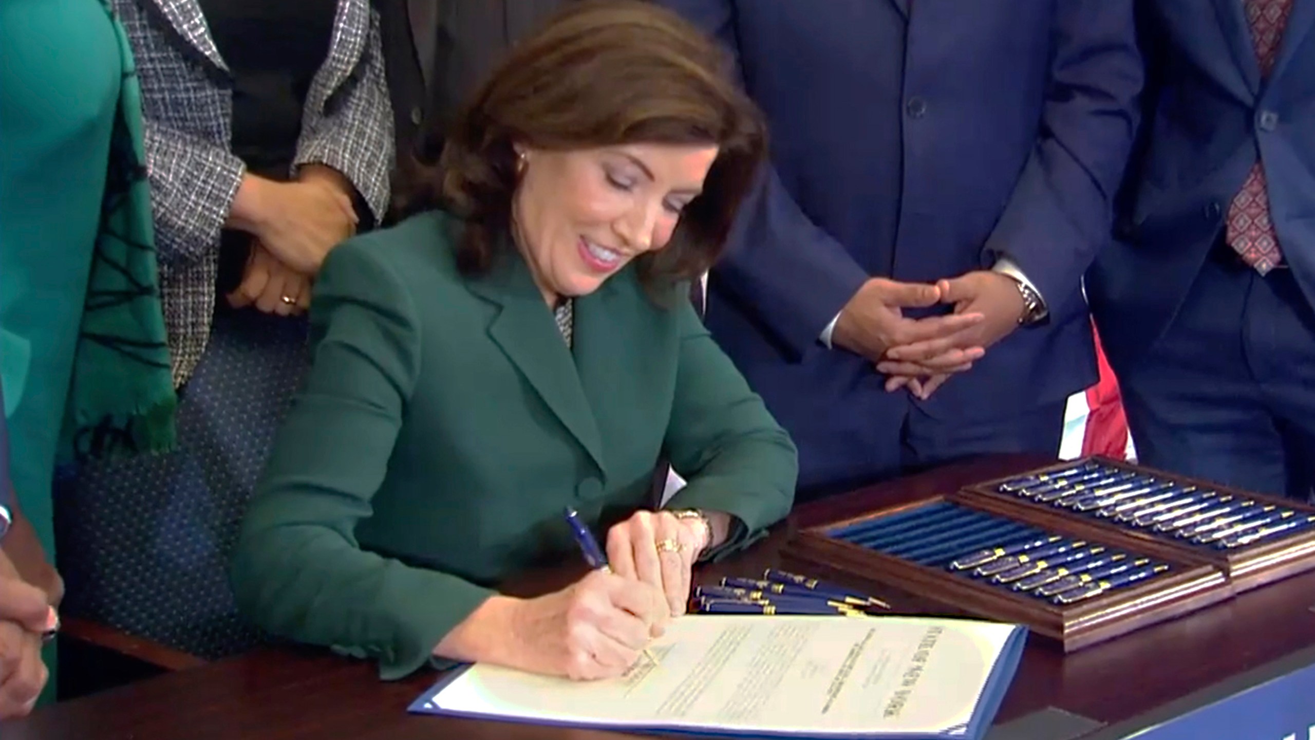 CORRECTS CITY TO NEW YORK - This image from video provided by the Office of The Governor shows New York Gov. Kathy Hochul as she signs a bill in New York, Tuesday, Dec. 19, 2023, to create a commission tasked with considering reparations to address the persistent, harmful effects of slavery in the state. (Office of the Governor via AP)