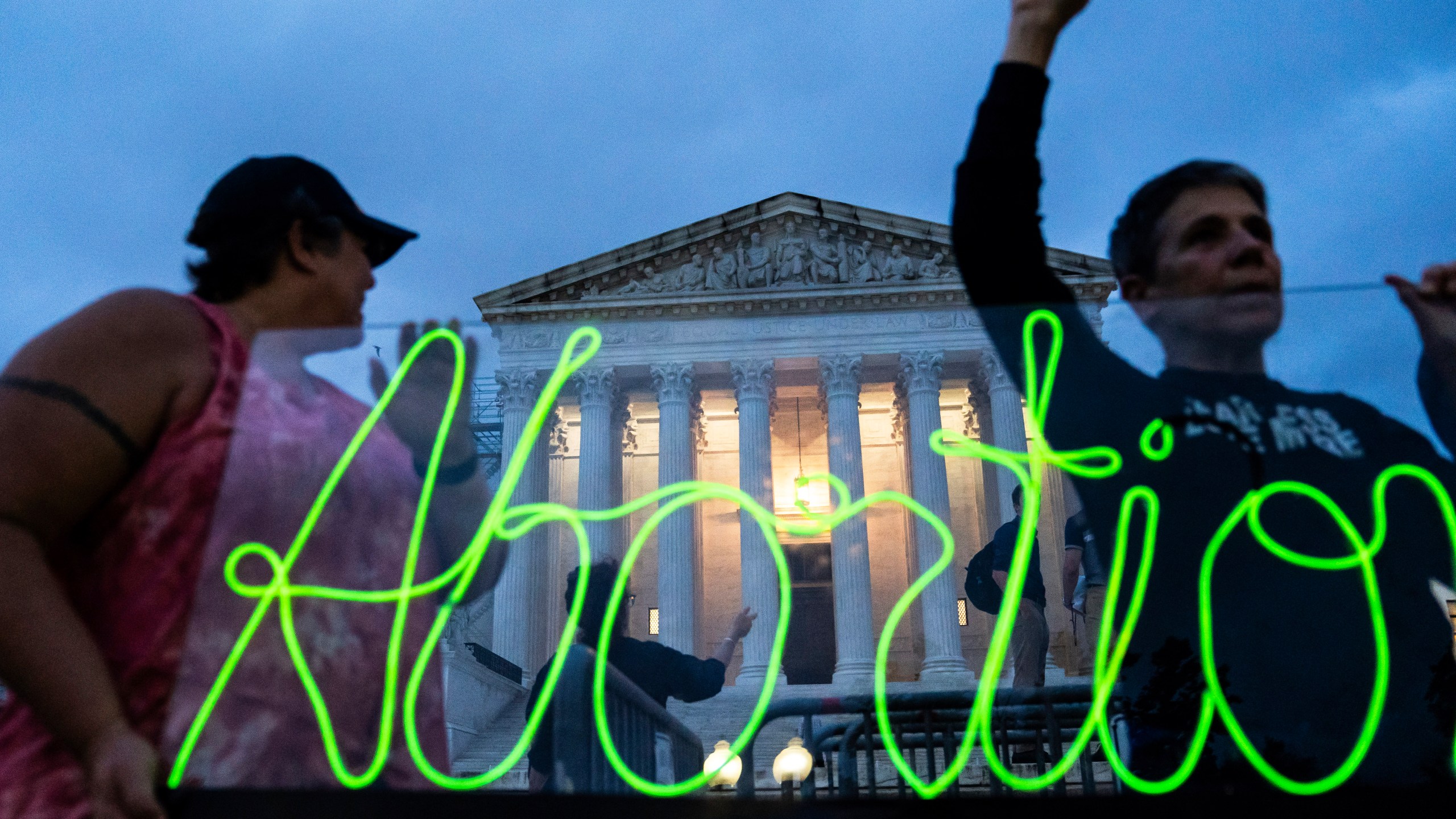 FILE - Activists mark the first anniversary of the Supreme Court's decision in Dobbs v. Jackson Women's Health Organization by displaying neon signage in support of abortion access, June 23, 2023, in Washington. Ever since the nation’s highest court ended abortion rights more than a year ago by overturning Roe v. Wade, vaguely worded bans enacted in some Republican-controlled states have caused bewilderment over how exceptions should be applied. (AP Photo/Nathan Howard, File)