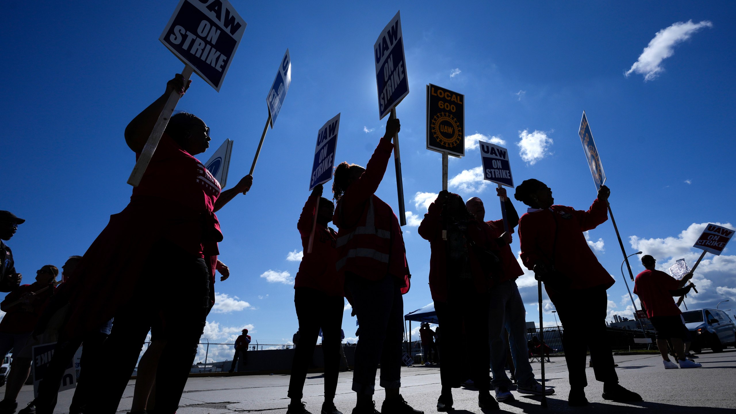 File - United Auto Workers members walk the picket line at the Ford Michigan Assembly Plant in Wayne, Mich., Sept. 18, 2023. The long-battered American labor movement flexed its muscle in 2023, taking advantage of widespread worker shortages to demand – and get -- better pay and benefits. (AP Photo/Paul Sancya, File)