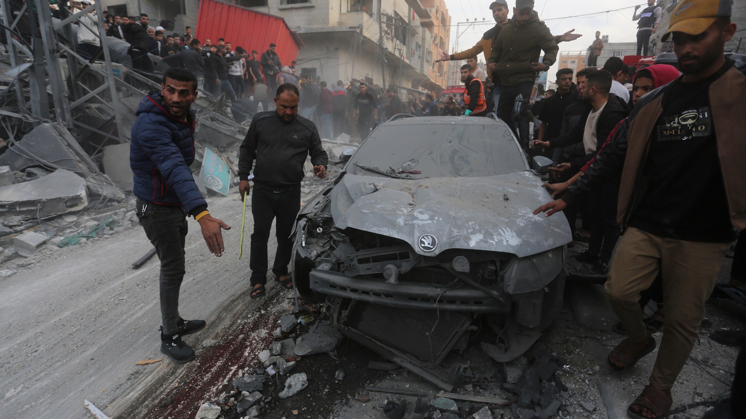 Palestinians look at the destruction after an Israeli strike in Rafah, Gaza Strip, Wednesday, Dec. 20, 2023. (AP Photo/Hatem Ali)