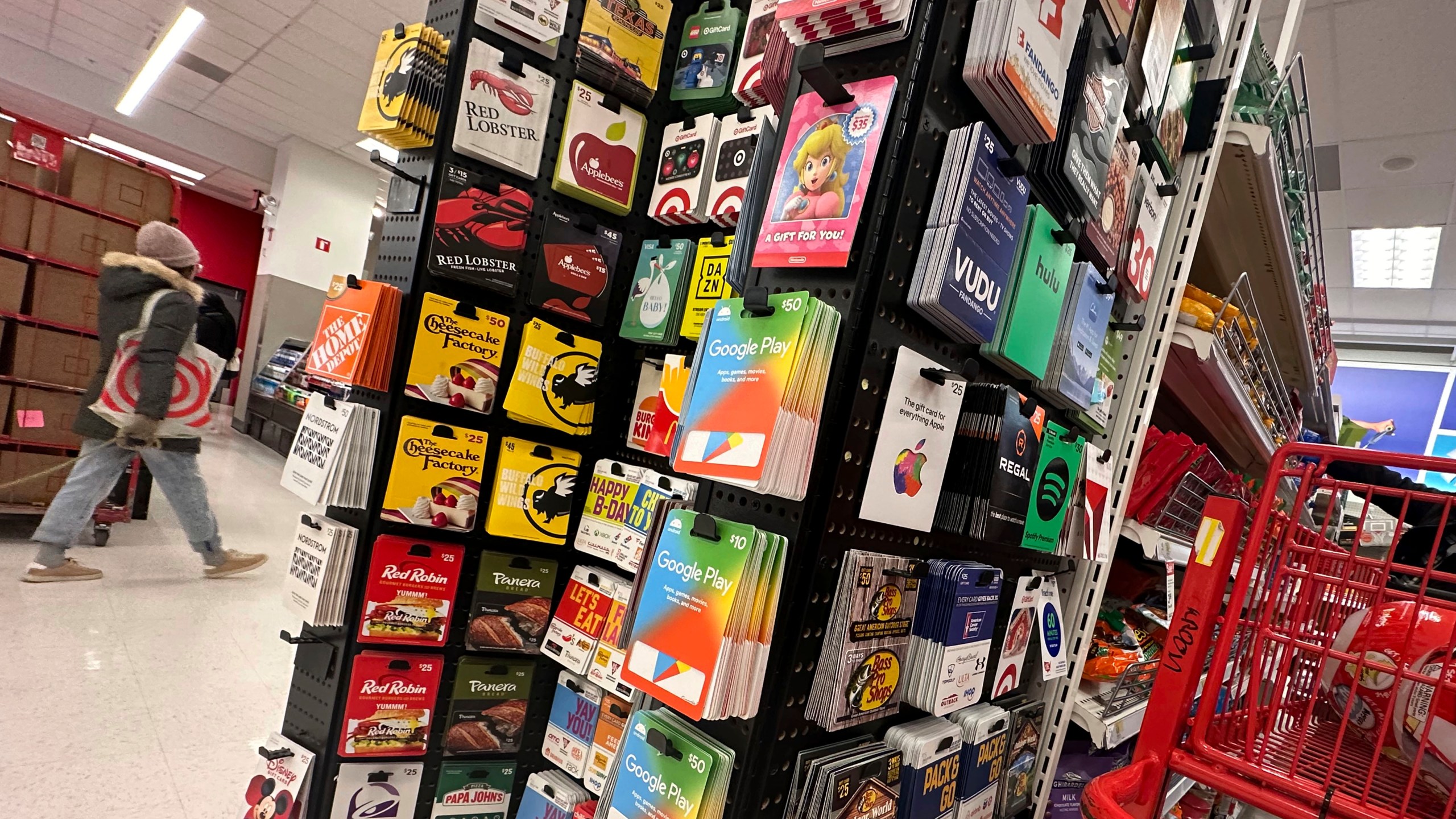 Gift cards are displayed at a Target store, in New York, Thursday, Dec. 21, 2023. Americans are expected to spend nearly $30 billion on gift cards this holiday season, according to the National Retail Federation. Restaurant gift cards are the most popular, making up one-third of those sales. (AP Photo/Richard Drew)