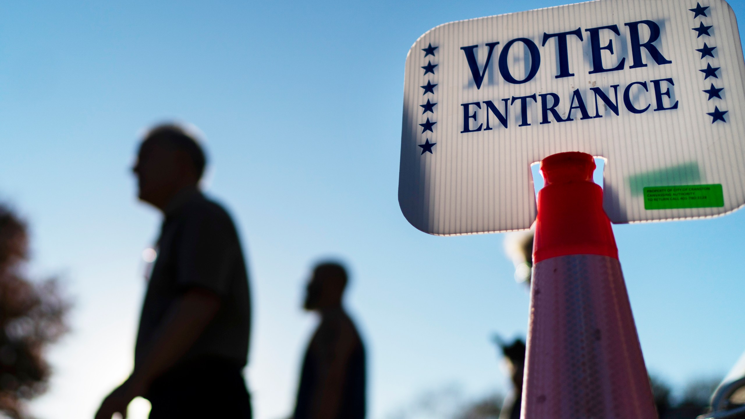 FILE - Voters pass a sign outside a polling site in Warwick, R.I., on Nov. 7, 2022. With the Republican primaries around the corner, a new poll finds that party members aren't sure votes in the presidential nominating contest will be counted accurately. Only about one-third of Republicans say they're confident that tallies in the primary will be accurate. That's according to a new AP-NORC poll. (AP Photo/David Goldman, File)