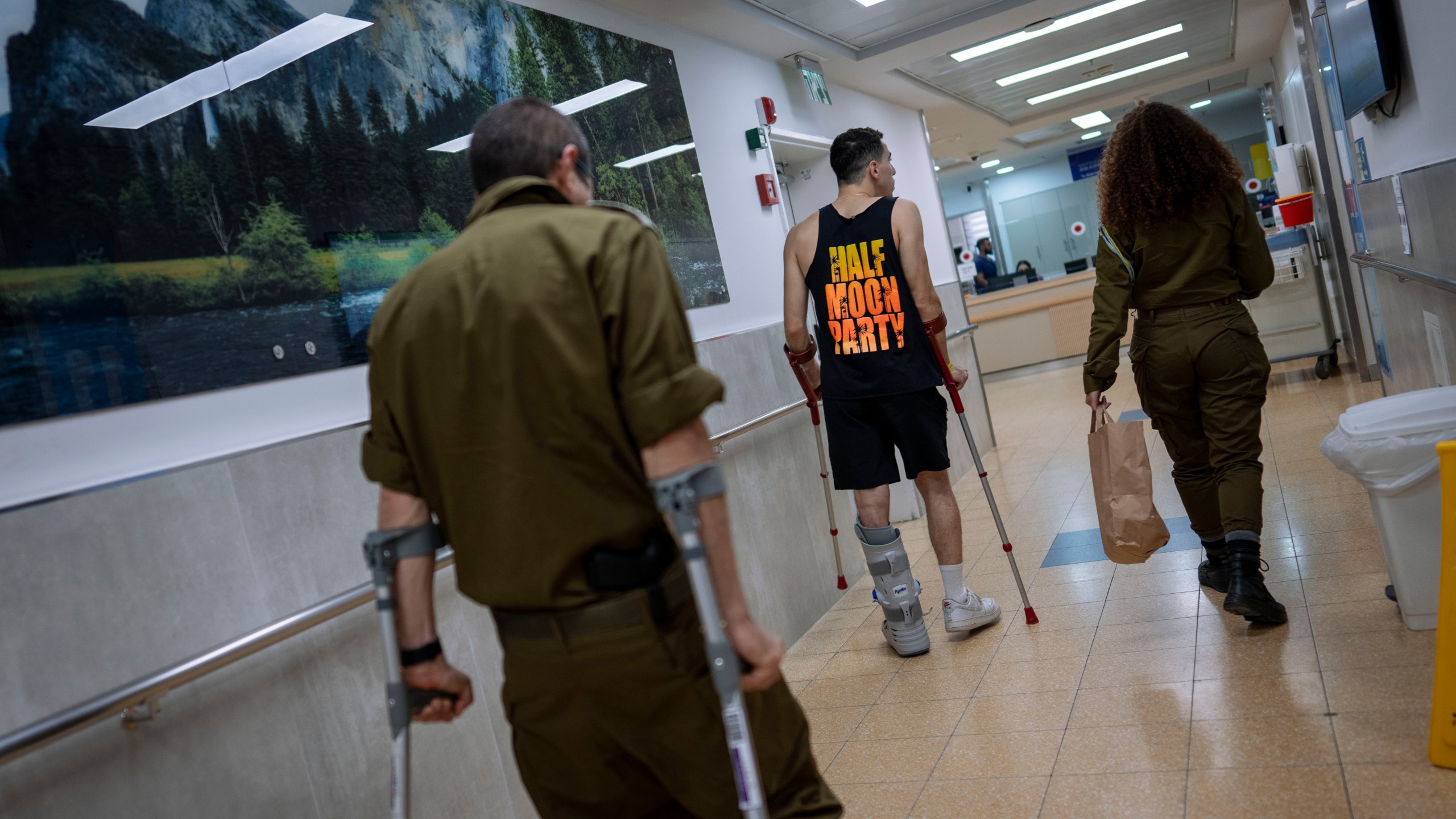 Israeli soldiers wounded in the war with Hamas walk in the rehabilitation division of Sheba hospital in Ramat Gan, Israel, Monday, Dec. 18, 2023. (AP Photo/Oded Balilty)