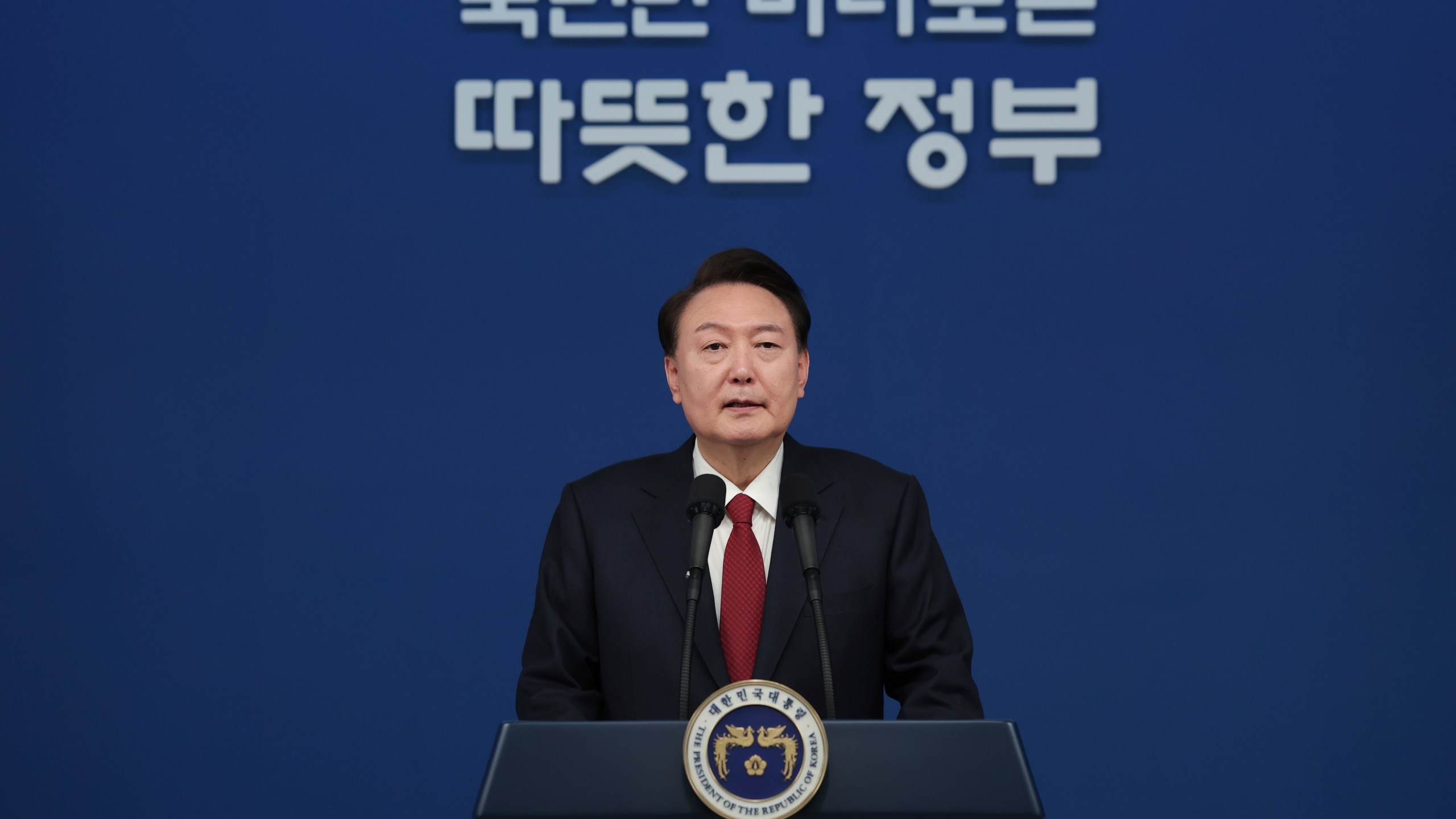 In this photo provided by South Korea Presidential Office, South Korean President Yoon Suk Yeol speaks during his New Year's speech at the presidential office in Seoul, South Korea, Monday, Jan. 1, 2024. (South Korea Presidential Office via AP)