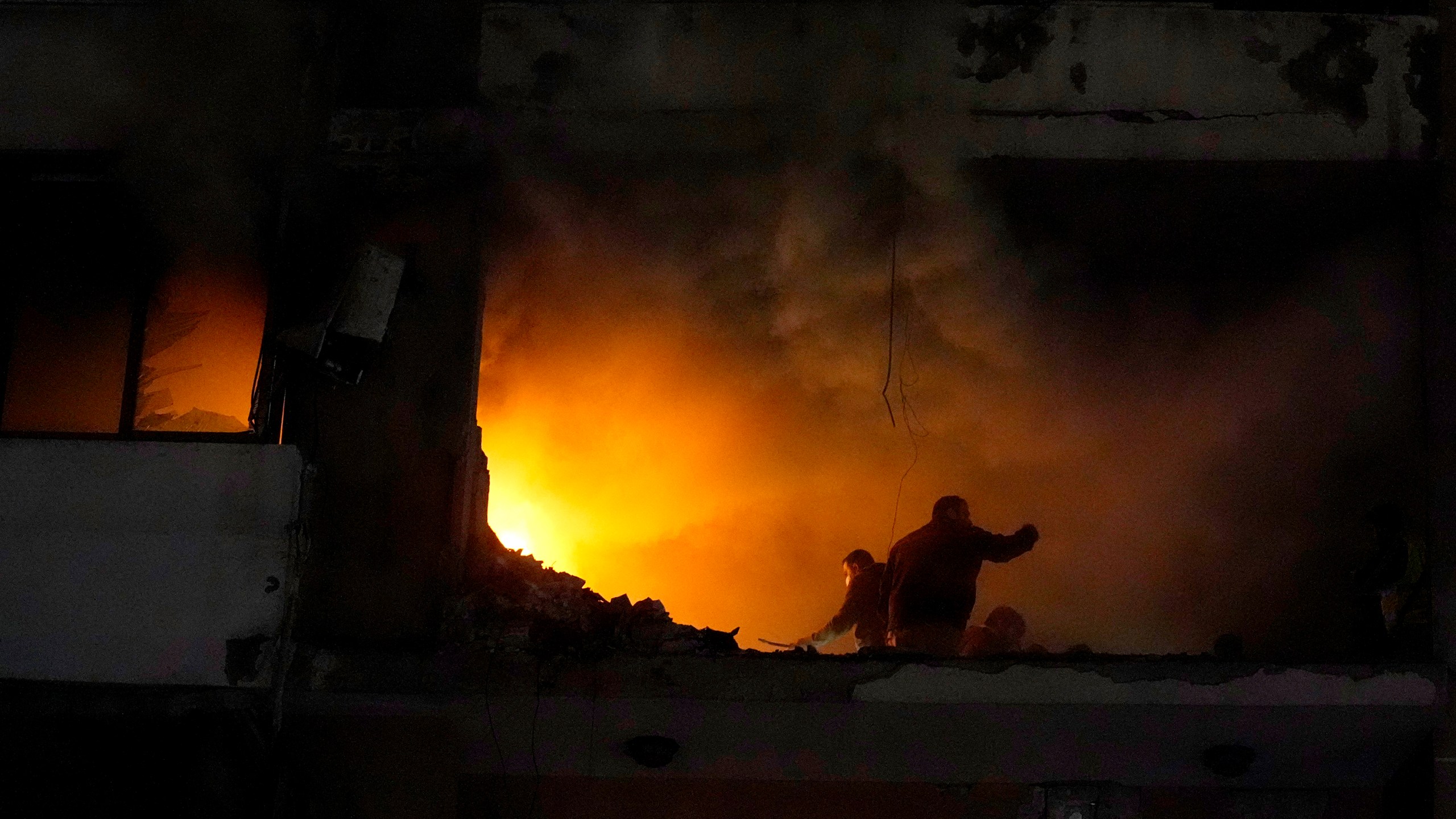 People search for survivors inside an apartment following a massive explosion in the southern Beirut suburb of Dahiyeh, Lebanon, Tuesday, Jan. 2, 2024. An explosion killed Saleh Arouri, a top official with the Palestinian militant group Hamas and three others, officials with Hamas and the Lebanese group Hezbollah said. (AP Photo/Bilal Hussein)