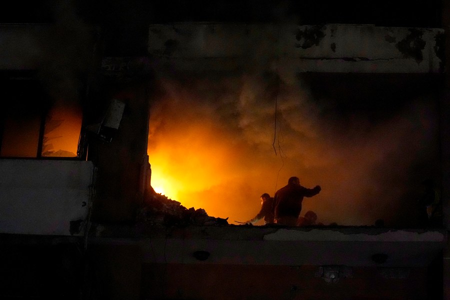 People search for survivors inside an apartment following a massive explosion in the southern Beirut suburb of Dahiyeh, Lebanon, Tuesday, Jan. 2, 2024. An explosion killed Saleh Arouri, a top official with the Palestinian militant group Hamas and three others, officials with Hamas and the Lebanese group Hezbollah said. (AP Photo/Bilal Hussein)