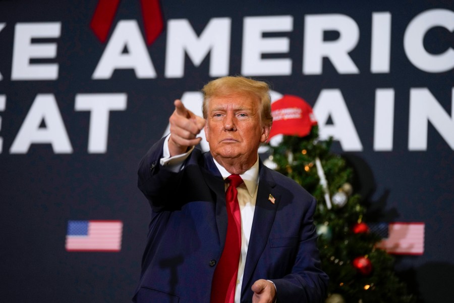 FILE - Former President Donald Trump points to supporters during rally Dec. 19, 2023, in Waterloo, Iowa. (AP Photo/Charlie Neibergall, File)