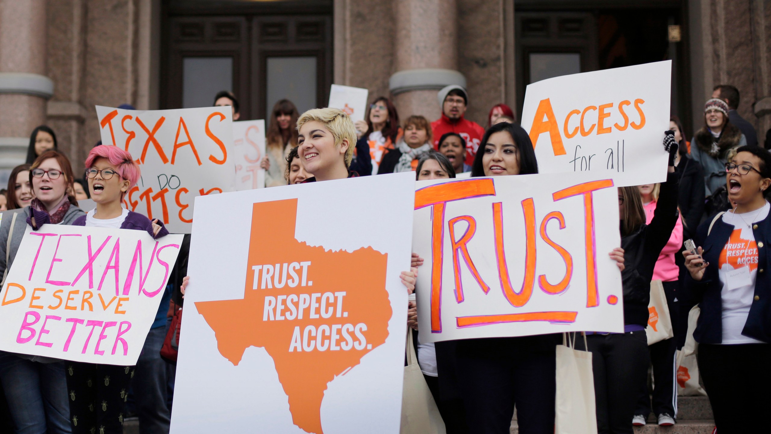 FILE - In this Feb. 26, 2015 file photo, college students and abortion rights activists hold signs during a rally on the steps of the Texas Capitol, in Austin, Texas. The Biden administration cannot use a 1986 emergency care law to require hospitals in Texas hospitals to provide abortions for women whose lives are at risk due to pregnancy, a federal appeals court ruled Tuesday, Jan. 2, 2024. It's one of numerous cases involving abortion restrictions that are playing out in state and federal courts after the U.S. Supreme Court ended abortion rights in 2022. (AP Photo/Eric Gay, File)