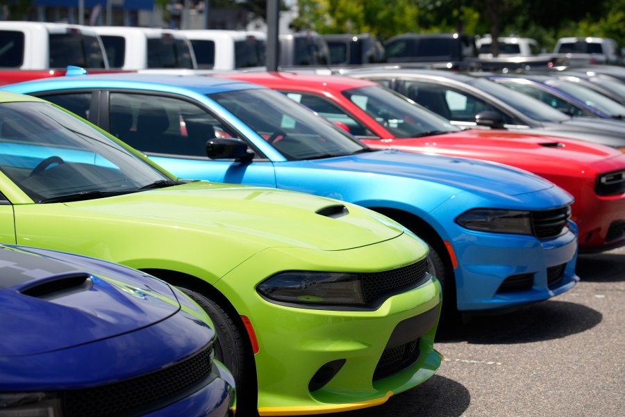 File - Unsold 2023 Charger sedans and Challenger hardtops sit at a Dodge dealership on June 18, 2023, in Littleton, Colo. Undeterred by high prices, rising interest rates, autoworker strikes and a computer chip shortage that slowed assembly lines, American consumers still bought 15.5 million new vehicles last year, 11% more than in 2022. (AP Photo/David Zalubowski, File)