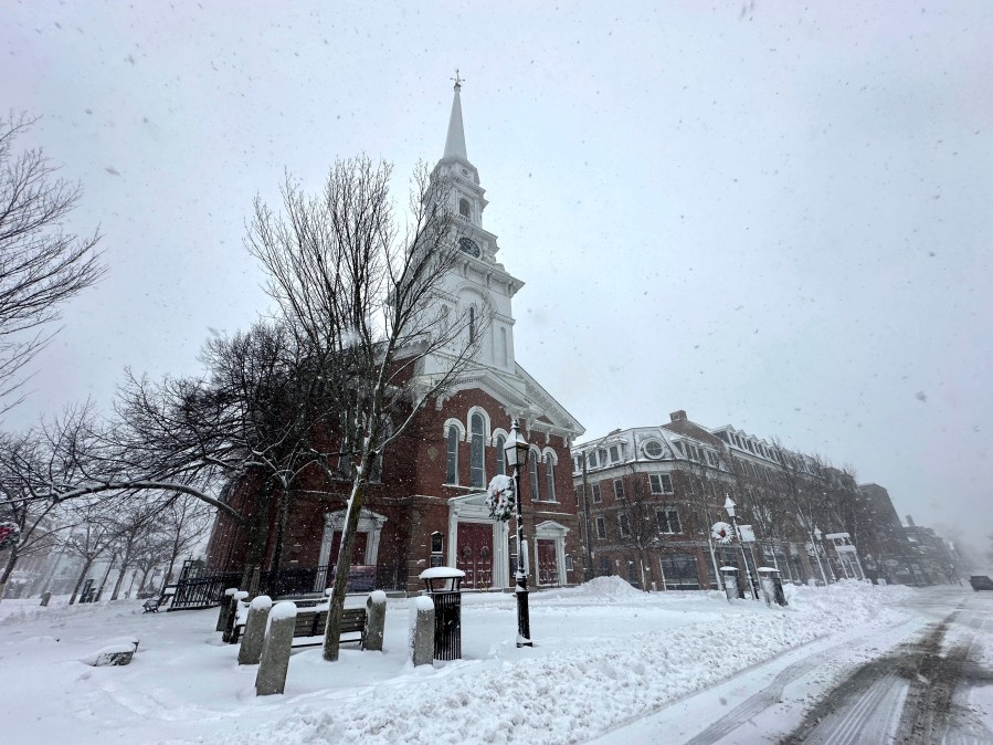 Snow falls in Portsmouth, N.H., Sunday, Jan. 7, 2024. A major winter storm bringing up to a foot of snow and freezing rain to some communities spread across New England Sunday sending residents scurrying to pull out their shovels and snow blowers to clear sidewalks and driveways. Winter storm warnings and watches were in effect throughout the Northeast, and icy roads made for hazardous travel as far south as North Carolina. (AP Photo/Caleb Jones)