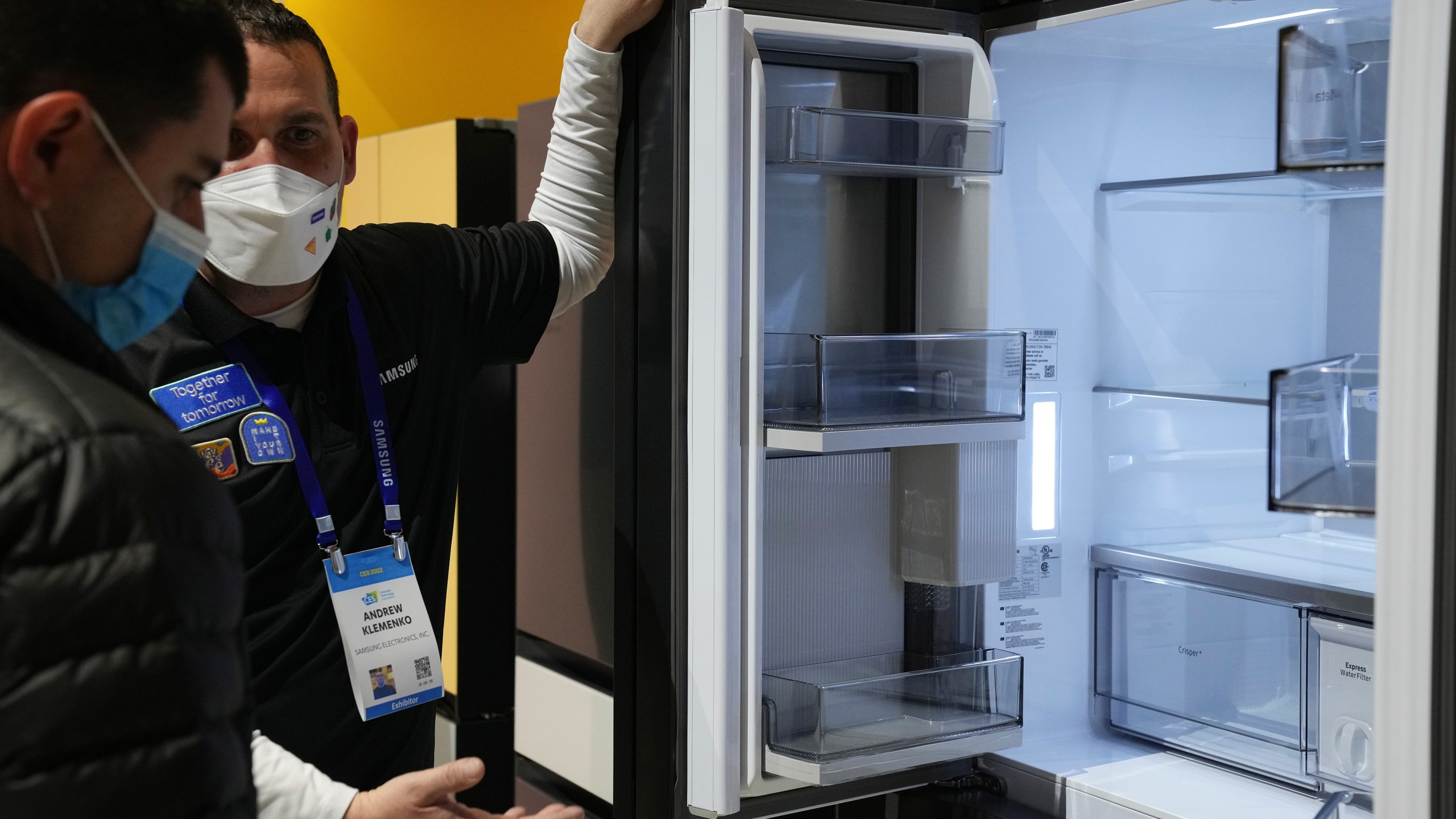 File - Andrew Klemenko shows off a Smart Counter Depth BESPOKE 4-Door Flex refrigerator at the Samsung booth during the CES tech show in Las Vegas. At the dawn of 2024, also known as New Year's resolution season, there are lots of small, easily achievable ways to lead more climate friendly lives. (AP Photo/Joe Buglewicz, File)