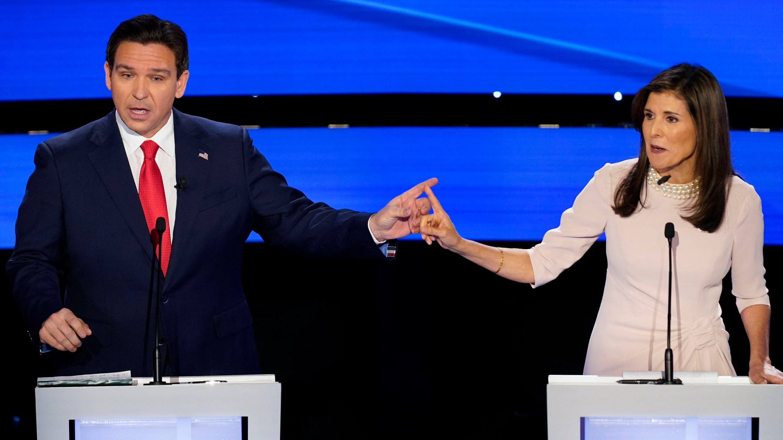 Former UN Ambassador Nikki Haley, right and Florida Gov. Ron DeSantis, left, pointing at each other during the CNN Republican presidential debate at Drake University in Des Moines, Iowa, Wednesday, Jan. 10, 2024. (AP Photo/Andrew Harnik)