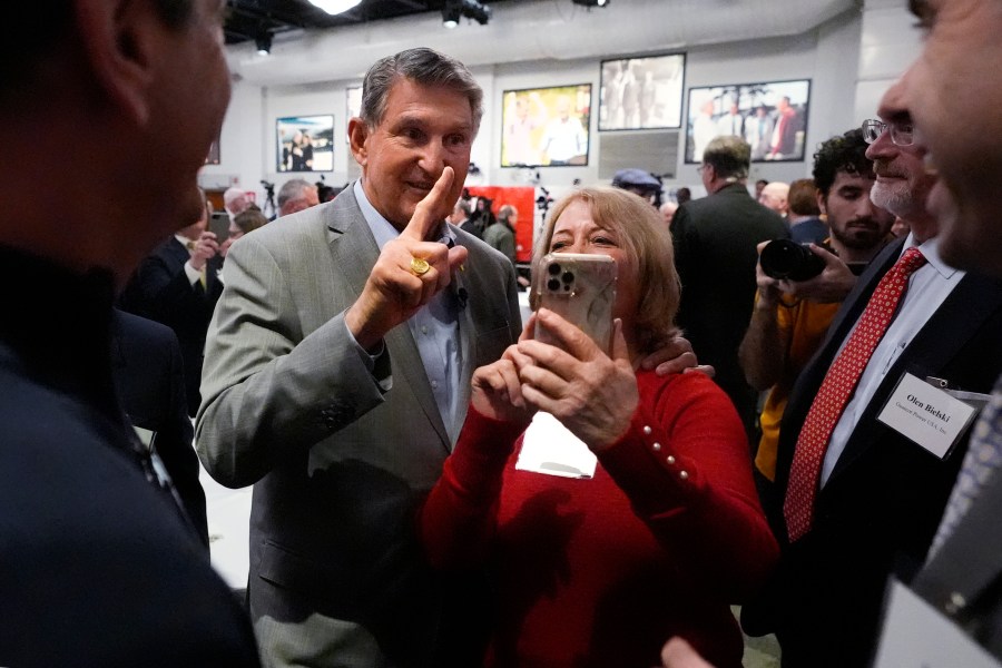 Sen. Joe Manchin, D-W.Va., left, poses with guests during the Politics and Eggs event, as part of his national listening tour, Friday, Jan. 12, 2024, in Manchester, N.H. Manchin announced last November that he would not seek reelection in 2024 and has teased a potential third-party run for the presidency. (AP Photo/Charles Krupa)