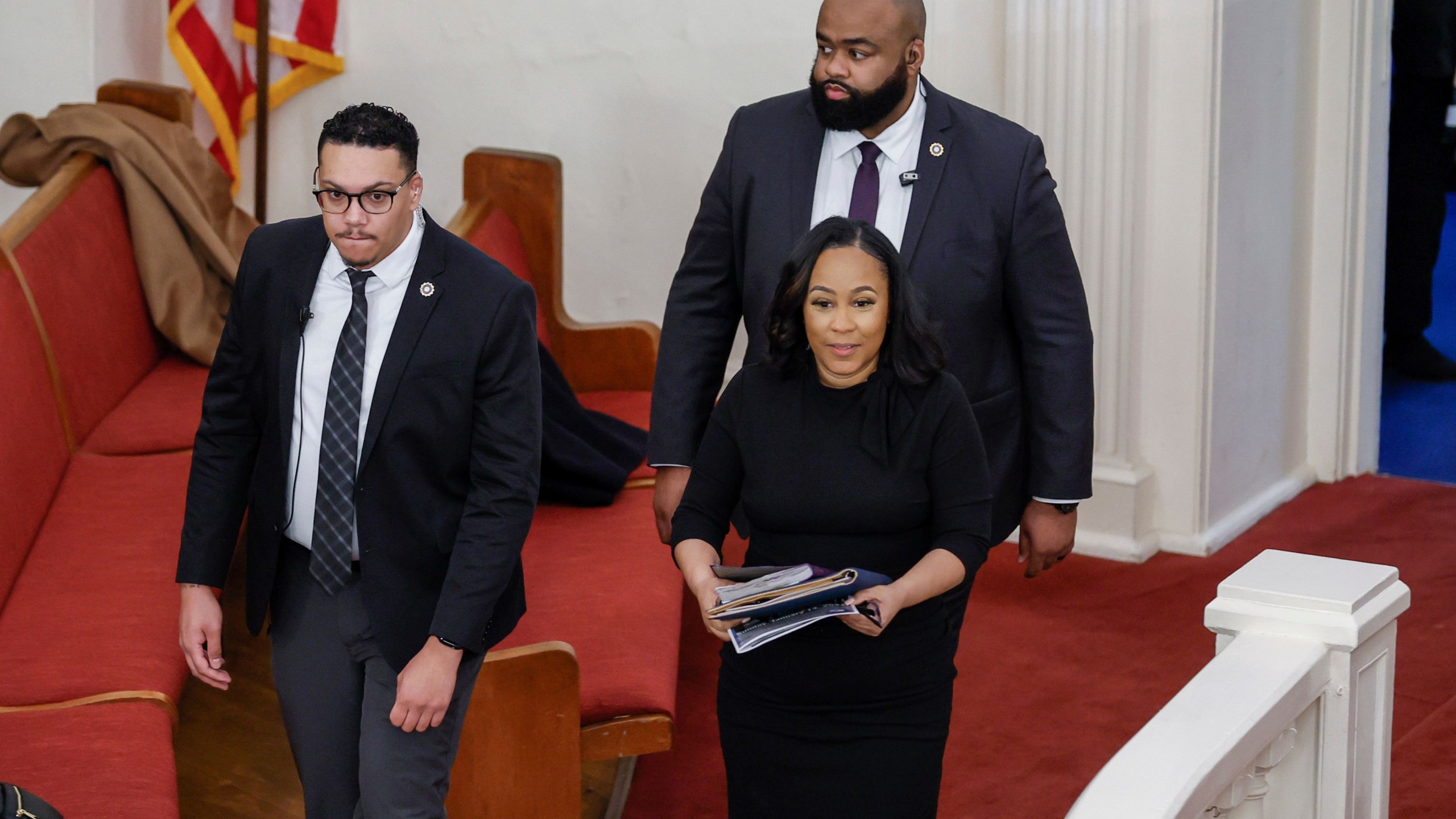 Fulton County District Attorney Fani Willis, right, enters the Big Bethel AME Church in Atlanta, moments before the worship service, where she was invited to speak on Sunday, Jan. 14, 2024. The service celebrated Rev. Martin Luther King Jr. at the historic Black church. (Miguel Martinez/Atlanta Journal-Constitution via AP)