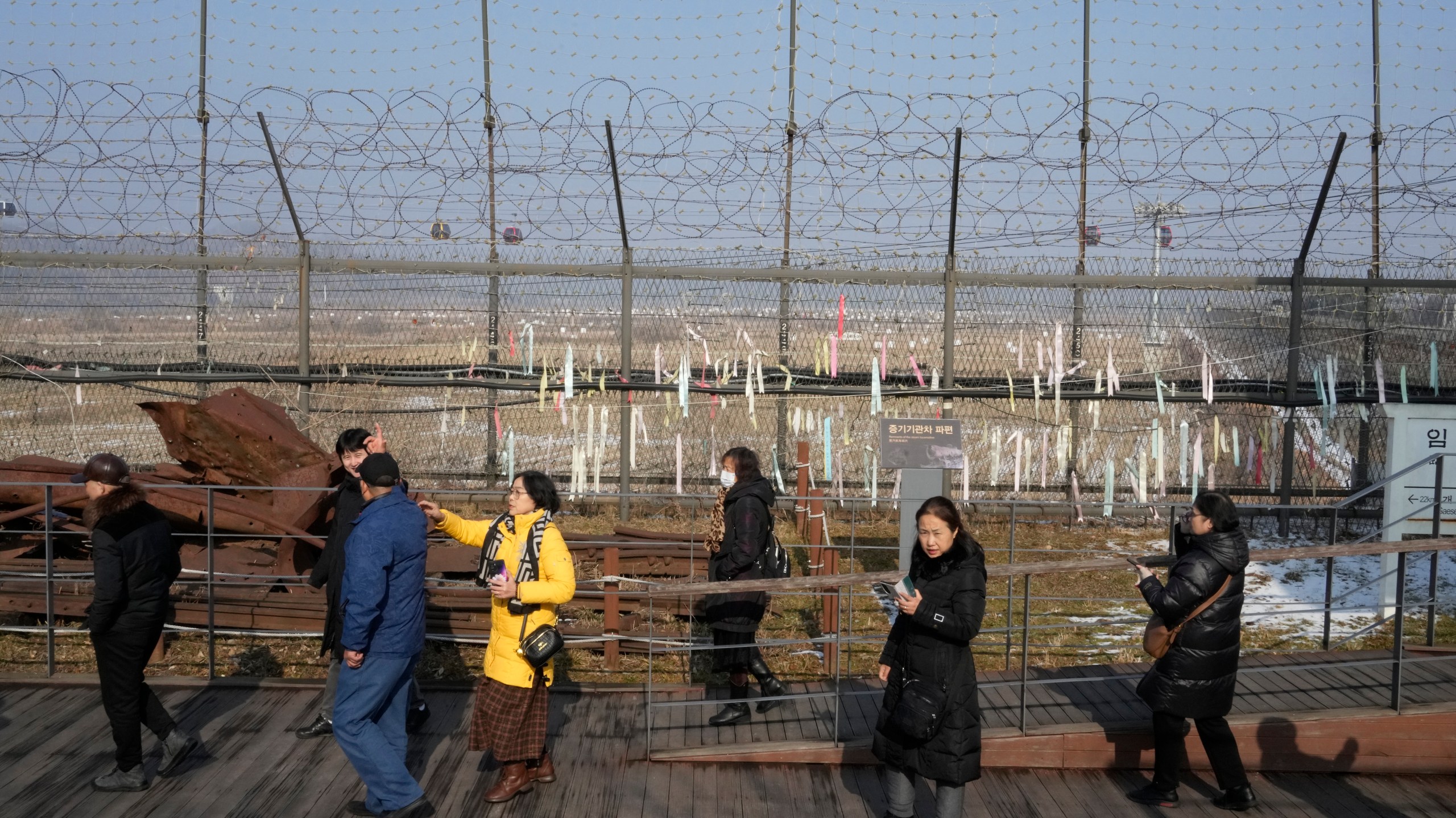 FILE - Visitors pass by a wire fence at the Imjingak Pavilion in Paju, South Korea, Wednesday, Jan. 10, 2024. North Korea has abolished key government organizations tasked with managing relations with South Korea, state media said Tuesday, Jan. 16, as authoritarian leader Kim Jong Un said he would no longer pursue reconciliation with his rival. (AP Photo/Ahn Young-joon, File)