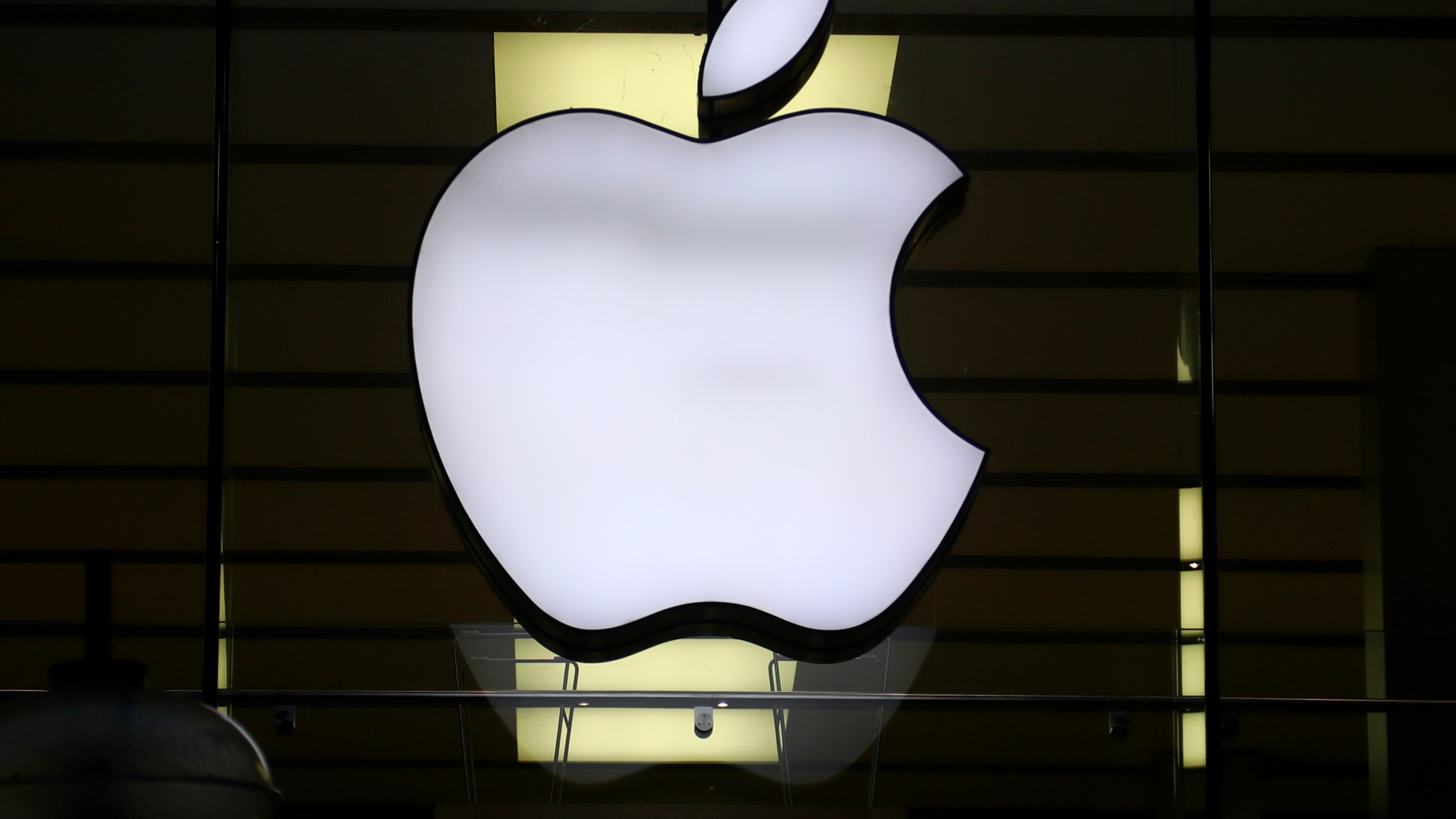 FILE - The Apple logo is illuminated at a store in the city center of Munich, Germany, Dec. 16, 2020. A potential redesign of two Apple Watch models, the Series 9 and Ultra 2, that would exclude the blood oxygen sensor has been approved by the U.S. Customs and Border Protection, according to a Monday, Jan. 15, 2024, court filing by Masimo, a Southern California company pursuing the patent claim. (AP Photo/Matthias Schrader, File)