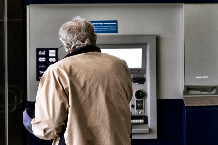 File - A customer makes a transaction at an automatic teller machine in Los Angeles on March 27, 2023. The cost to overdraw a bank account could drop to as little as $3 under a proposal announced by the White House, the latest move by the Biden administration to combat fees it says pose an unnecessary burden on American consumers, particularly those living paycheck to paycheck. (AP Photo/Richard Vogel, File)