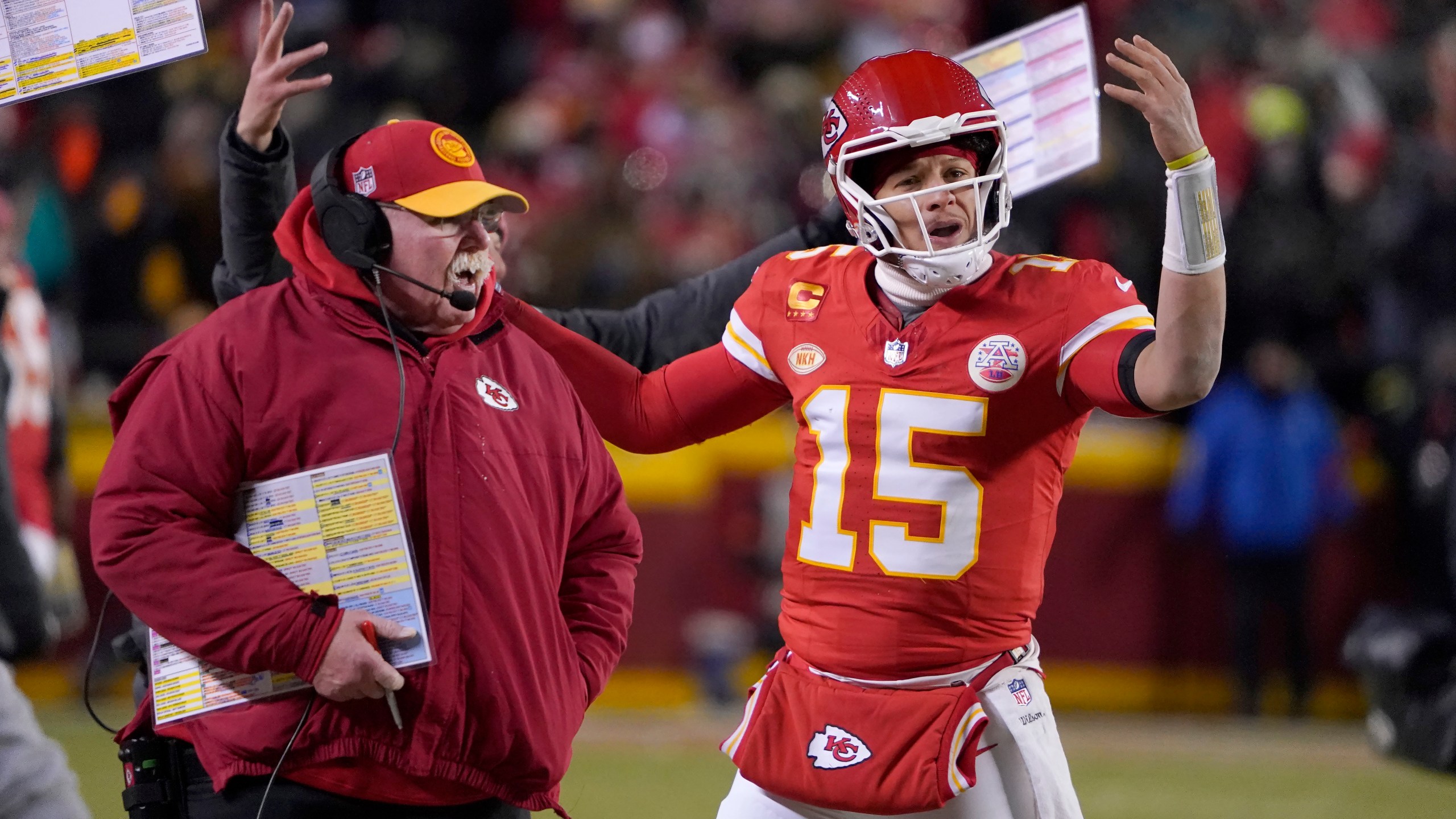 Kansas City Chiefs head coach Andy Reid, left, and quarterback Patrick Mahomes (15) react toward officials during the first half of an NFL wild-card playoff football game against the Miami Dolphins Saturday, Jan. 13, 2024, in Kansas City, Mo. (AP Photo/Ed Zurga)