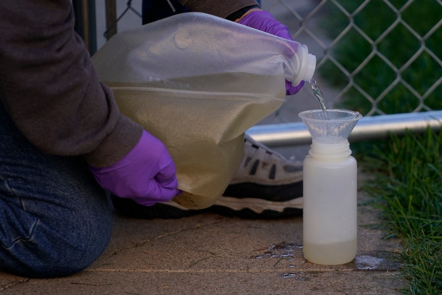 FILE - A professor collects sewage samples from a dorm at Utah State University Wednesday, Sept. 2, 2020, in Logan, Utah., to monitor wastewater in hopes of stopping coronavirus outbreaks before they get out of hand. According to a report by the U.S. Centers for Disease Control and Prevention released Thursday, Jan. 18, 2024, wastewater testing does a good job at detecting mpox infections, bolstering a push to use sewage to track more and more diseases. (AP Photo/Rick Bowmer, File)