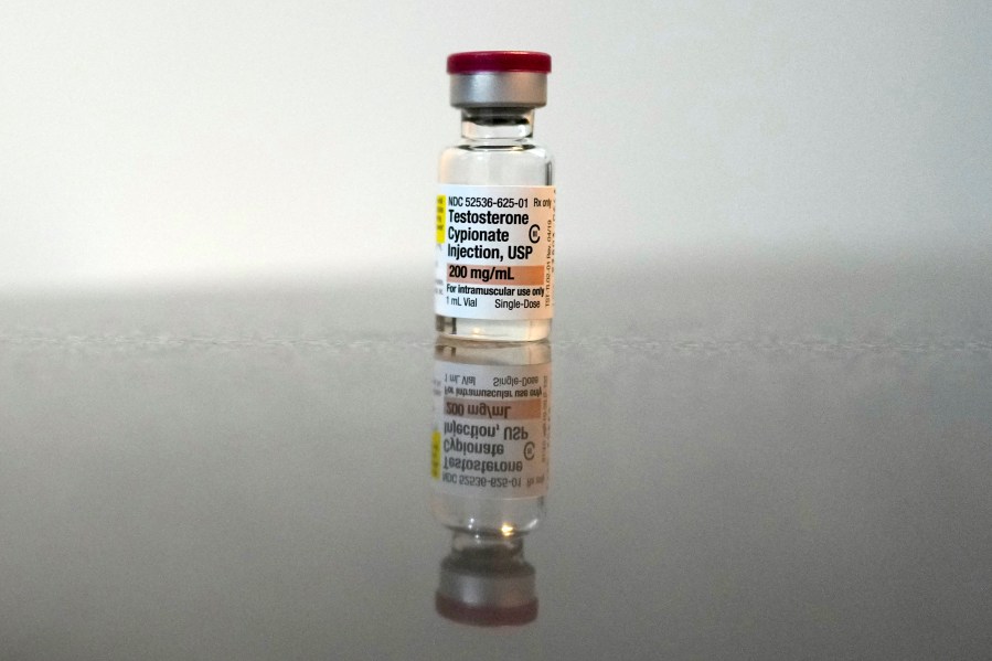 A vial of Testosterone Cypionate Injection is seen on the bathroom counter in Ashton Colby's apartment in Columbus, Ohio, on Thursday, Jan. 18, 2024. Ohio Gov. Mike DeWine announced proposals this month that transgender advocates say could block access to gender-affirming care provided by independent clinics and general practitioners, leaving thousands of adults scrambling for treatment and facing health risks. Colby, 31, fears the clinic where he gets the testosterone he has taken since age 19 would no longer offer it. (AP Photo/Carolyn Kaster)