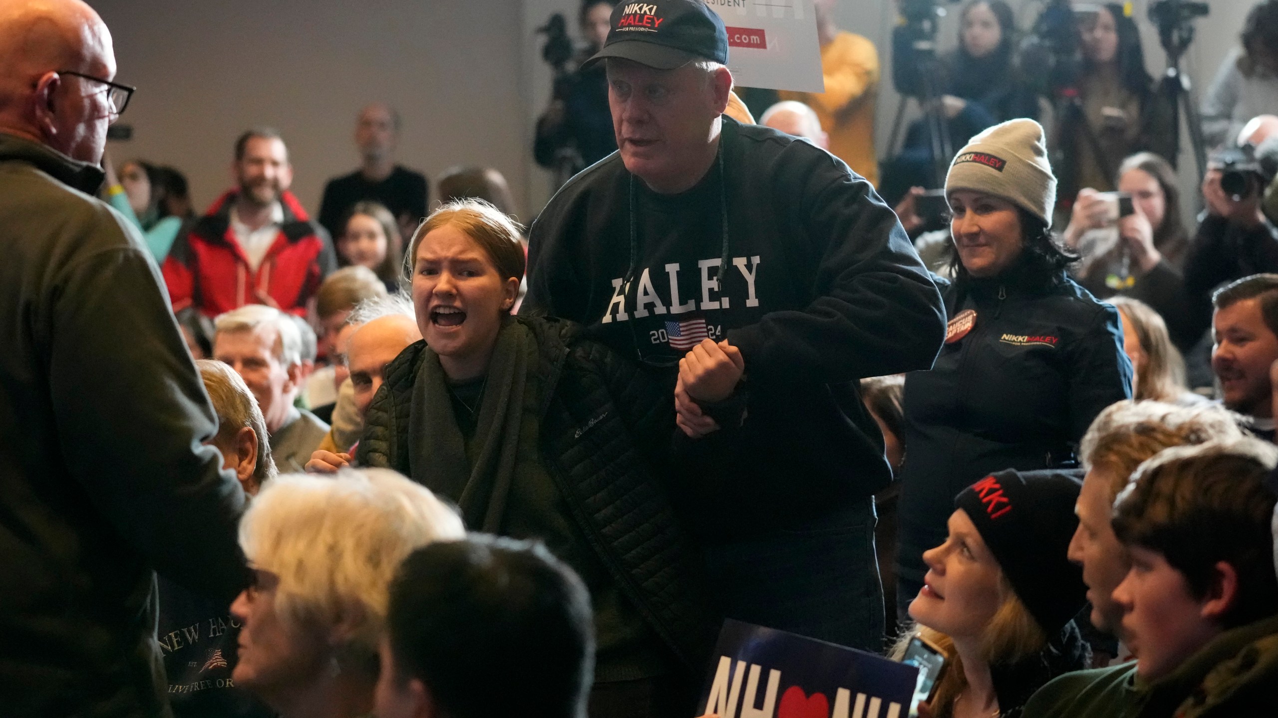 A climate protester is removed by security at a rally held by Republican presidential candidate former U.N. Ambassador Nikki Haley, Saturday, Jan. 20, 2024, in Nashua, N.H. (AP Photo/Robert F. Bukaty)