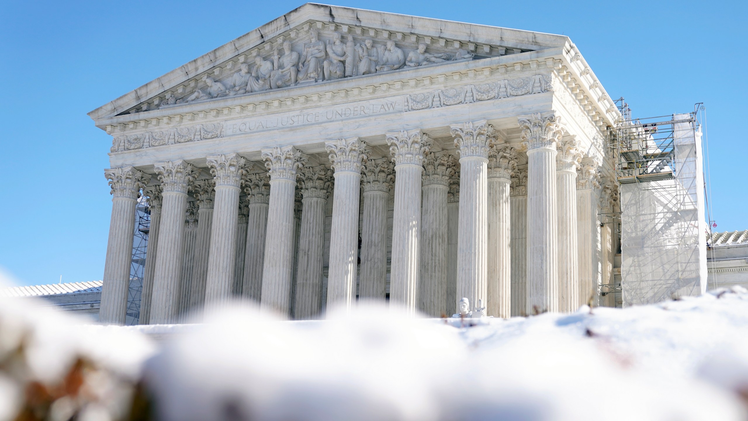 The U.S. Supreme Court is photographed through snow on Wednesday, Jan. 17, 2024, in Washington. (AP Photo/Mariam Zuhaib)