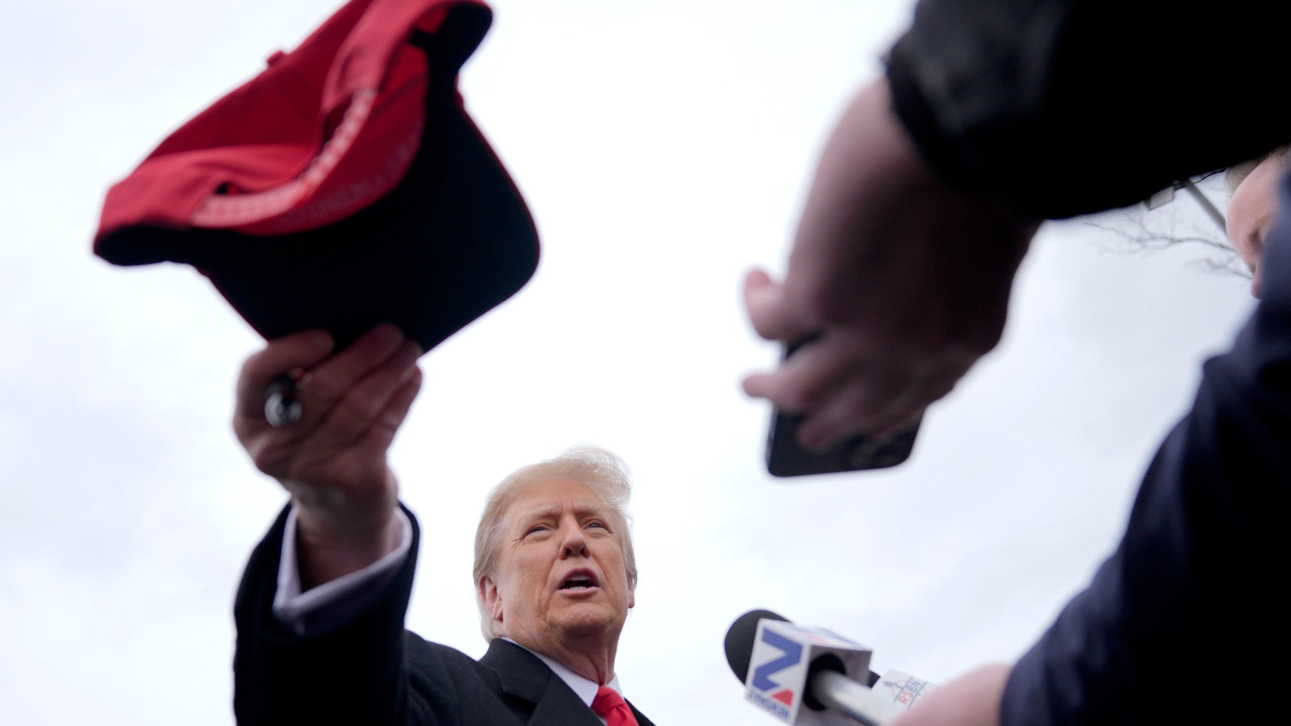 Republican presidential candidate former President Donald Trump hands off a signed hat during a campaign stop in Londonderry, N.H., Tuesday, Jan. 23, 2024. (AP Photo/Matt Rourke)