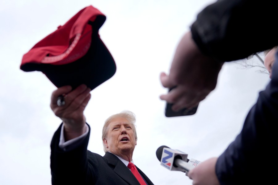 Republican presidential candidate former President Donald Trump hands off a signed hat during a campaign stop in Londonderry, N.H., Tuesday, Jan. 23, 2024. (AP Photo/Matt Rourke)