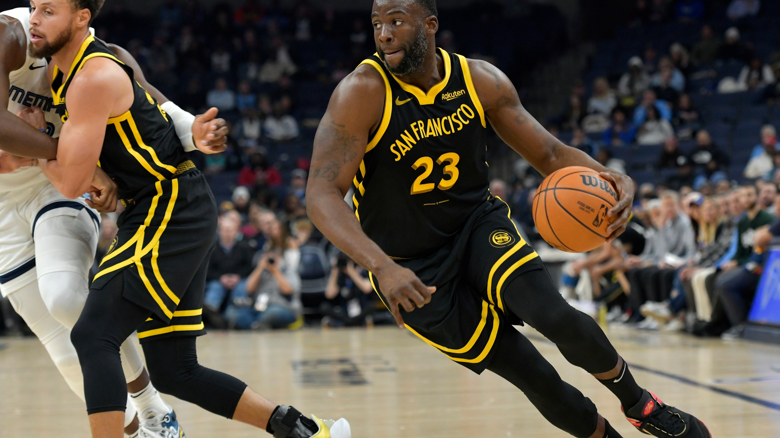 Golden State Warriors forward Draymond Green (23) handles the ball in the first half of an NBA basketball game against the Memphis Grizzlies, Monday, Jan. 15, 2024, in Memphis, Tenn. (AP Photo/Brandon Dill)