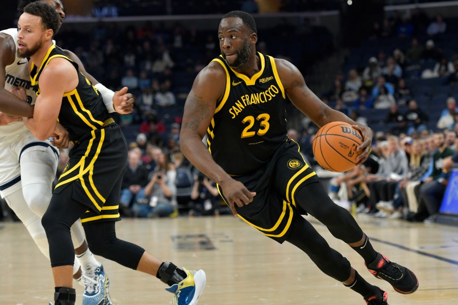 Golden State Warriors forward Draymond Green (23) handles the ball in the first half of an NBA basketball game against the Memphis Grizzlies, Monday, Jan. 15, 2024, in Memphis, Tenn. (AP Photo/Brandon Dill)