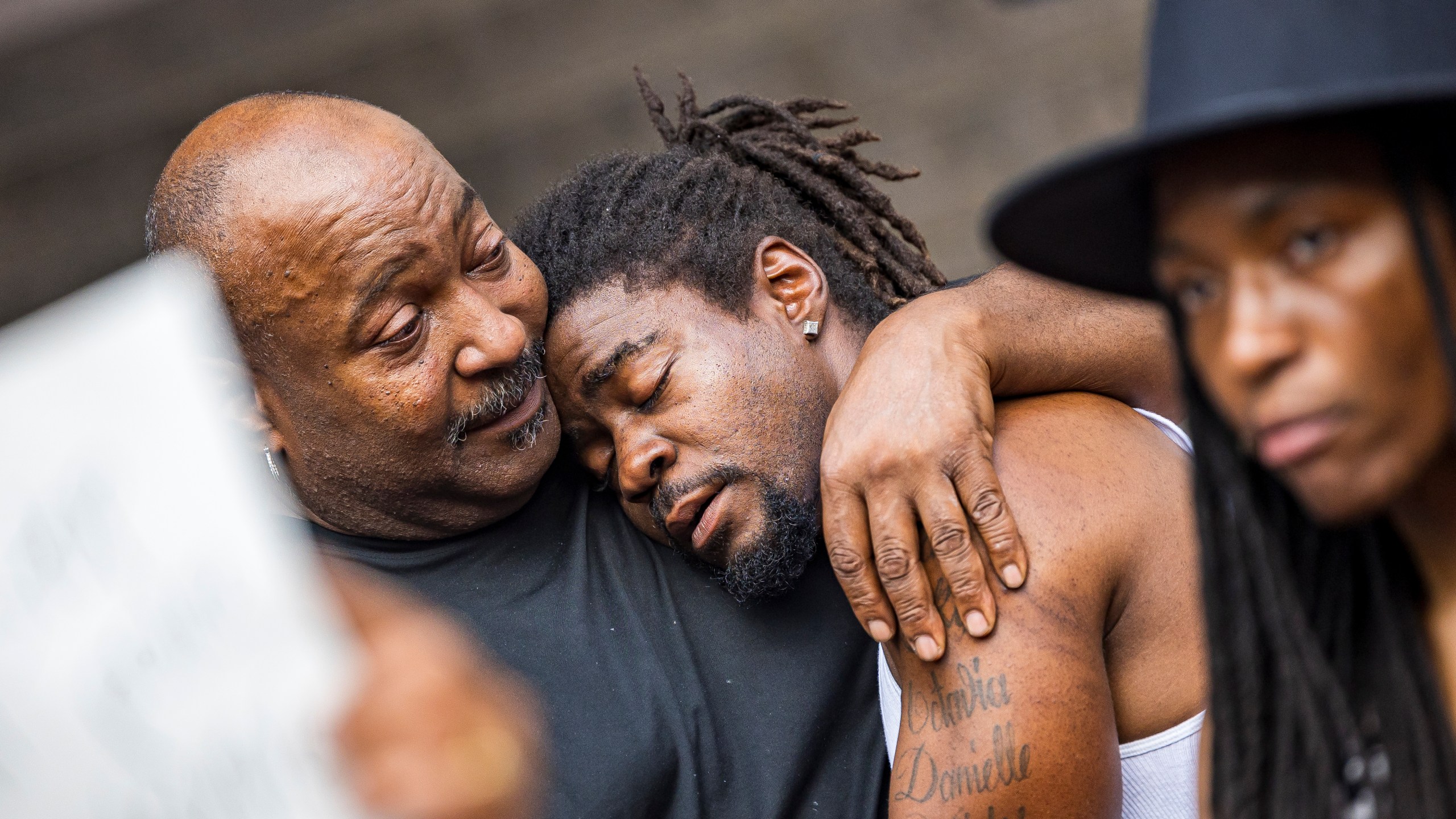 Rashad Cobb, Ricky Cobb II's twin brother, leans on the shoulders of relatives during a news conference outside the Hennepin County Government Center on Aug. 2, 2023, in Minneapolis. A Minnesota State Patrol trooper has been charged with murder in the shooting of motorist Ricky Cobb II after he failed to get out of his car during a July traffic stop. Trooper Ryan Londregan was charged with second-degree unintentional murder, first-degree assault and second degree manslaughter in the death of Cobb, a 33-year-old Black man. Hennepin County Attorney Mary Moriarty announced the charges at a news conference on Wednesday, Jan. 24, 2024. (Kerem Yücel/Minnesota Public Radio via AP)