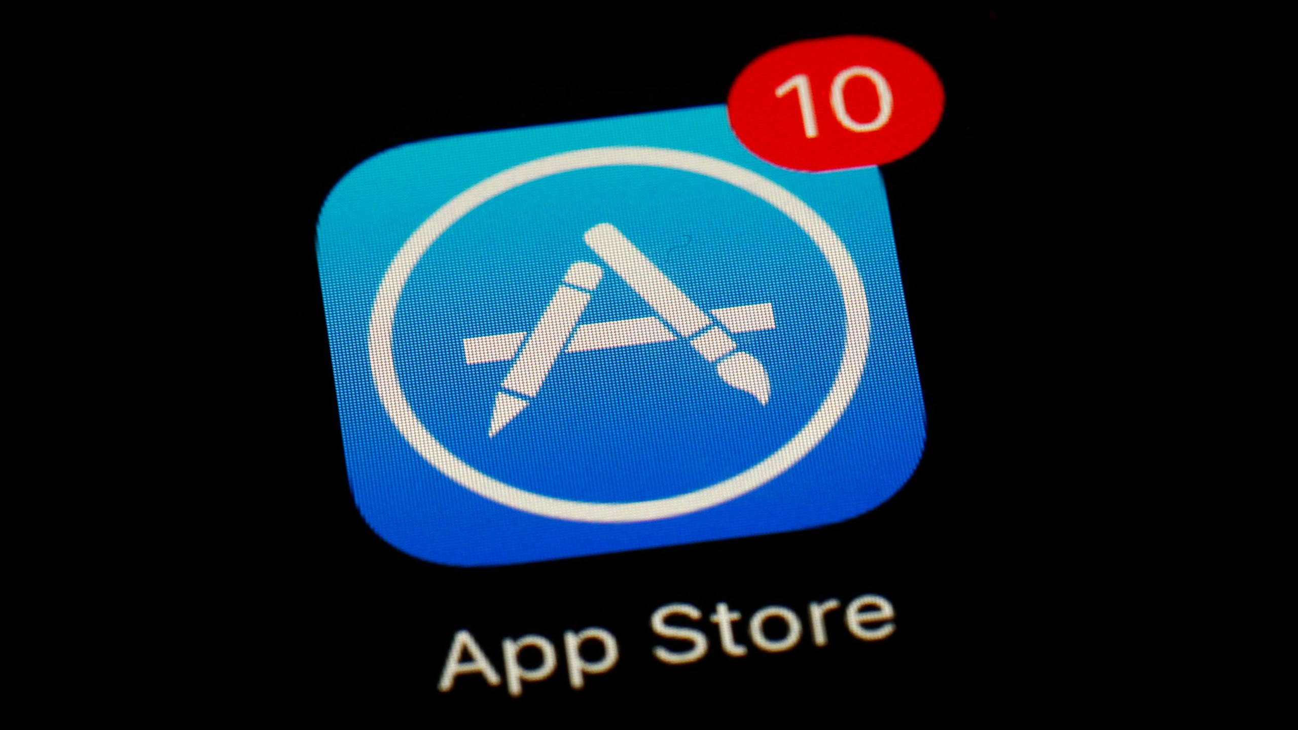 FILE - Apple's App Store icon is displayed on an iPad in Baltimore, March 19, 2018. Apple has unveiled a sweeping plan to tear down some of the competitive barriers that it has built around its lucrative iPhone franchise. The announcement Thursday, Jan. 25, 2024, comes as it moves to comply with upcoming European regulations aimed at giving consumers the choice to use alternative app stores. (AP Photo/Patrick Semansky, File)