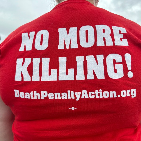 Anti-death penalty activists place signs along the road heading to Holman Correctional Facility in Atmore, Alabama.