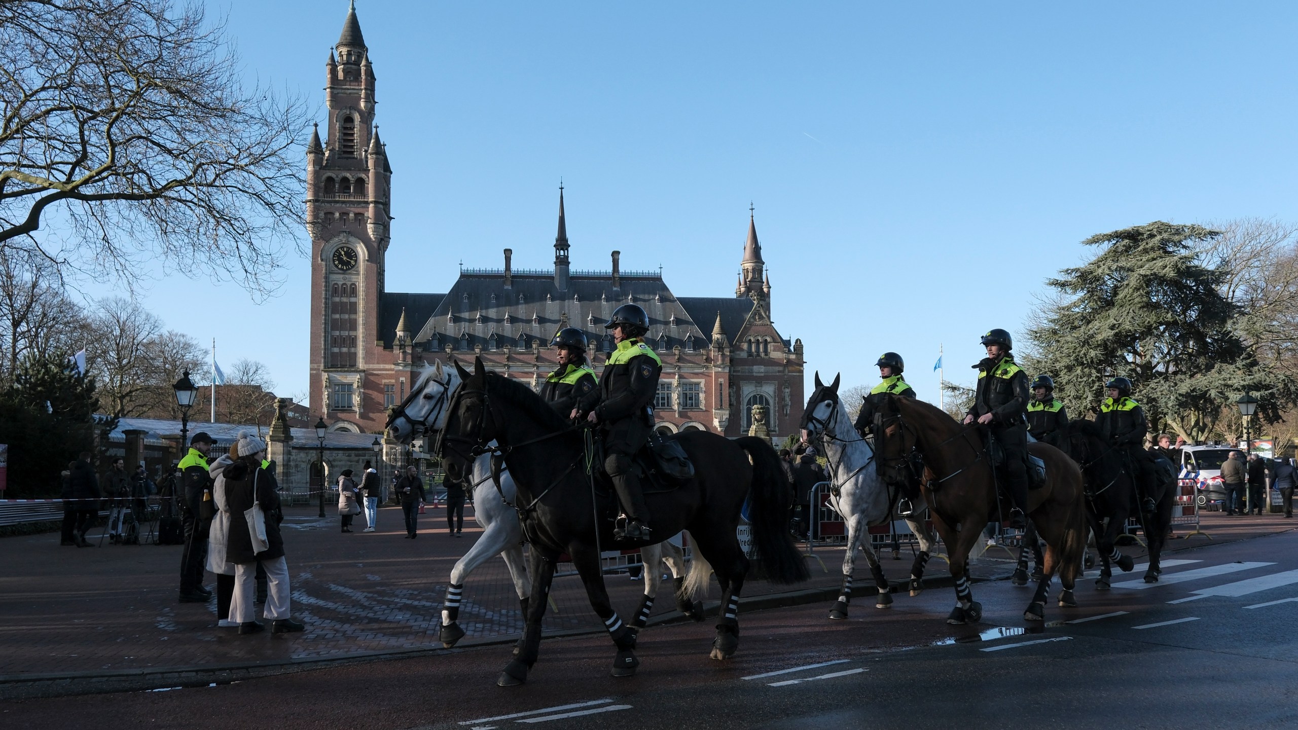 Police are on horsebacks outside the Peace Palace, which houses the International Court of Justice, or World Court, in The Hague, Netherlands, Friday, Jan. 26, 2024. Israel is set to hear whether the United Nations' top court will order it to end its military offensive in Gaza during a case filed by South Africa accusing Israel of genocide. (AP Photo/Patrick Post)