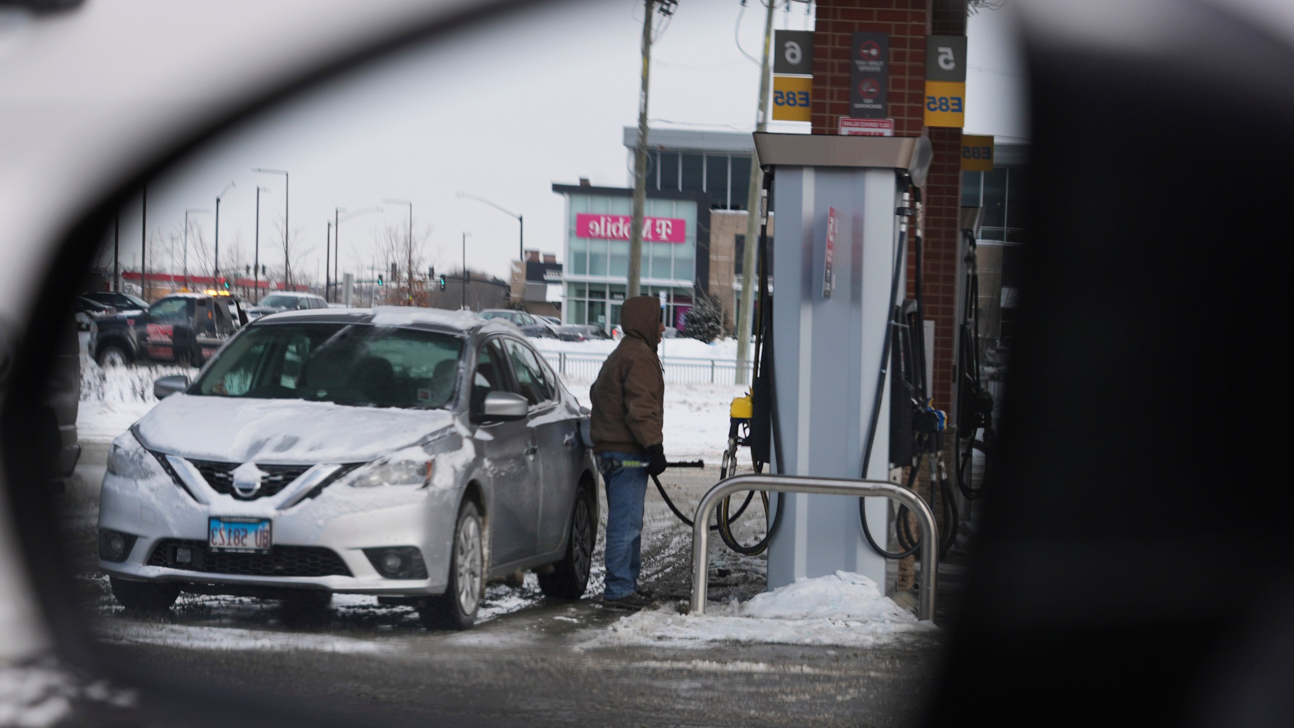 A customer pumps fuel at a gas station in Riverwoods, Ill., Friday, Jan. 19, 2024. On Friday, the Commerce Department issues its December report on consumer spending. (AP Photo/Nam Y. Huh)