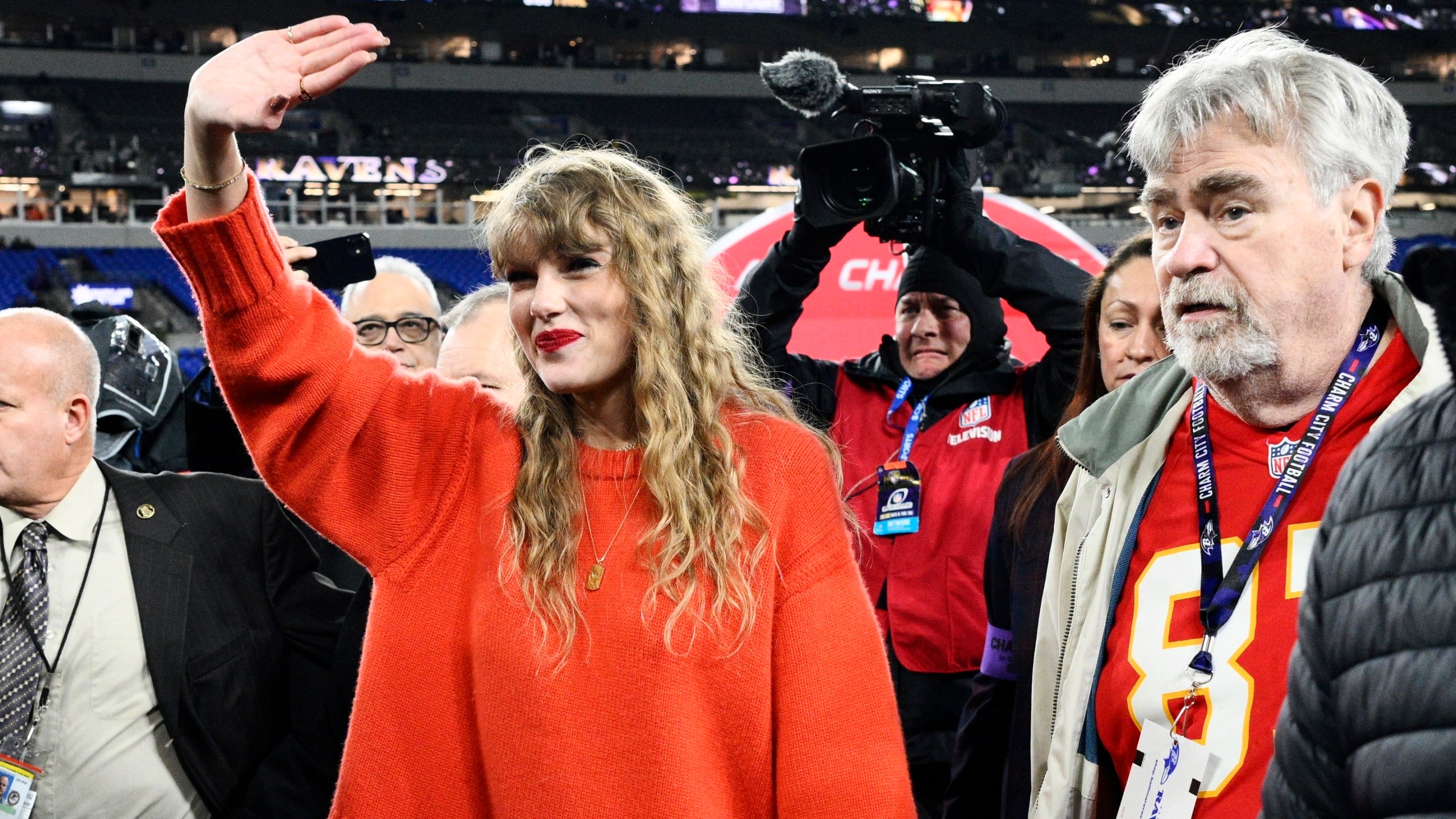 Taylor Swift waves as she walks with Ed Kelce after the AFC Championship NFL football game between the Baltimore Ravens and the Kansas City Chiefs, Sunday, Jan. 28, 2024, in Baltimore. The Chiefs won 17-10. (AP Photo/Nick Wass)