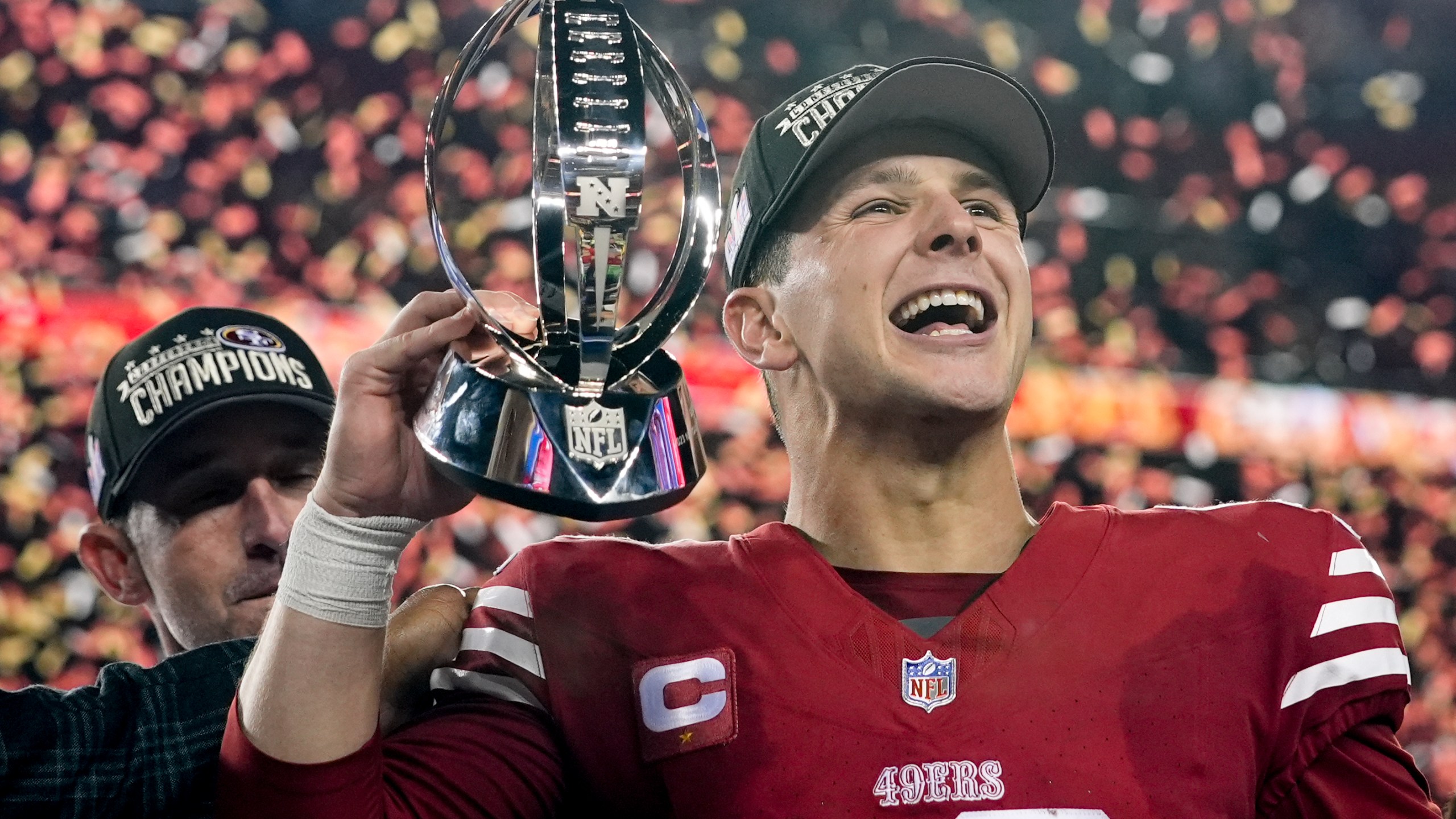 San Francisco 49ers quarterback Brock Purdy celebrates with the trophy after their win against the Detroit Lions in the NFC Championship NFL football game in Santa Clara, Calif., Sunday, Jan. 28, 2024. (AP Photo/Godofredo A. Vasquez)