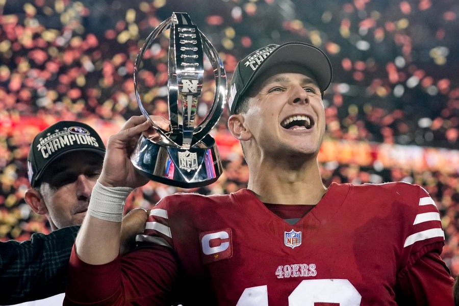 San Francisco 49ers quarterback Brock Purdy celebrates with the trophy after their win against the Detroit Lions in the NFC Championship NFL football game in Santa Clara, Calif., Sunday, Jan. 28, 2024. (AP Photo/Godofredo A. Vasquez)