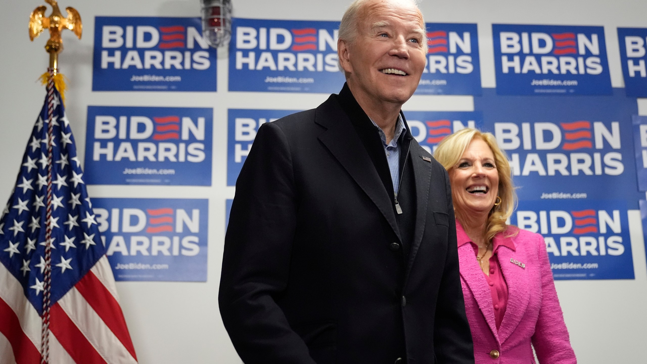 President Joe Biden, left, waits to speak as first lady Jill Biden looks on at the Biden campaign headquarters in Wilmington, Del., Saturday, Feb. 3, 2024. (AP Photo/Alex Brandon)